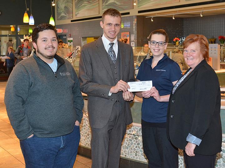 Organizers of Miss-A-Meal drive, Auxiliary Services staff pose with check