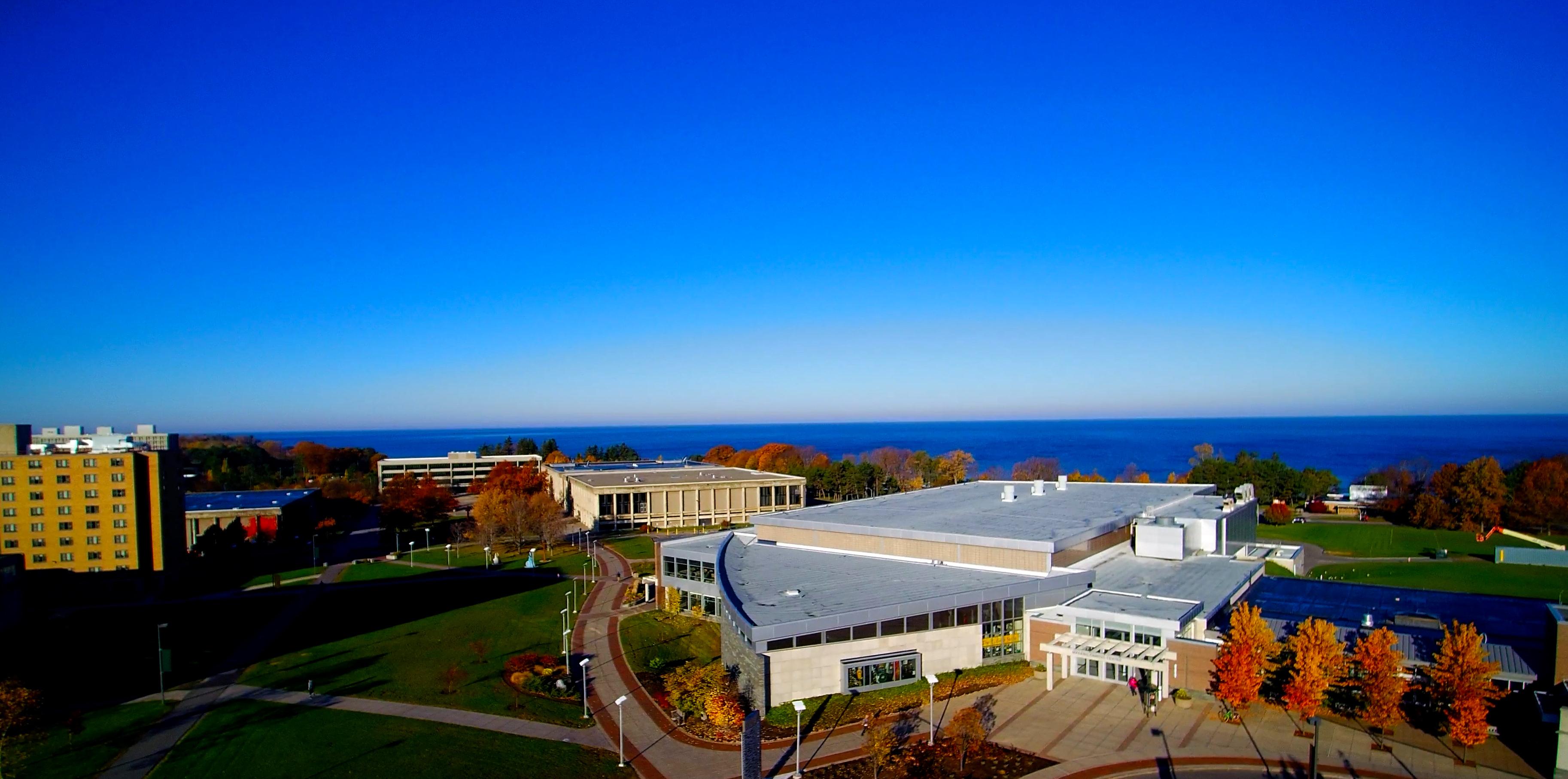 Aerial view of campus with fall foliage and Lake Ontario