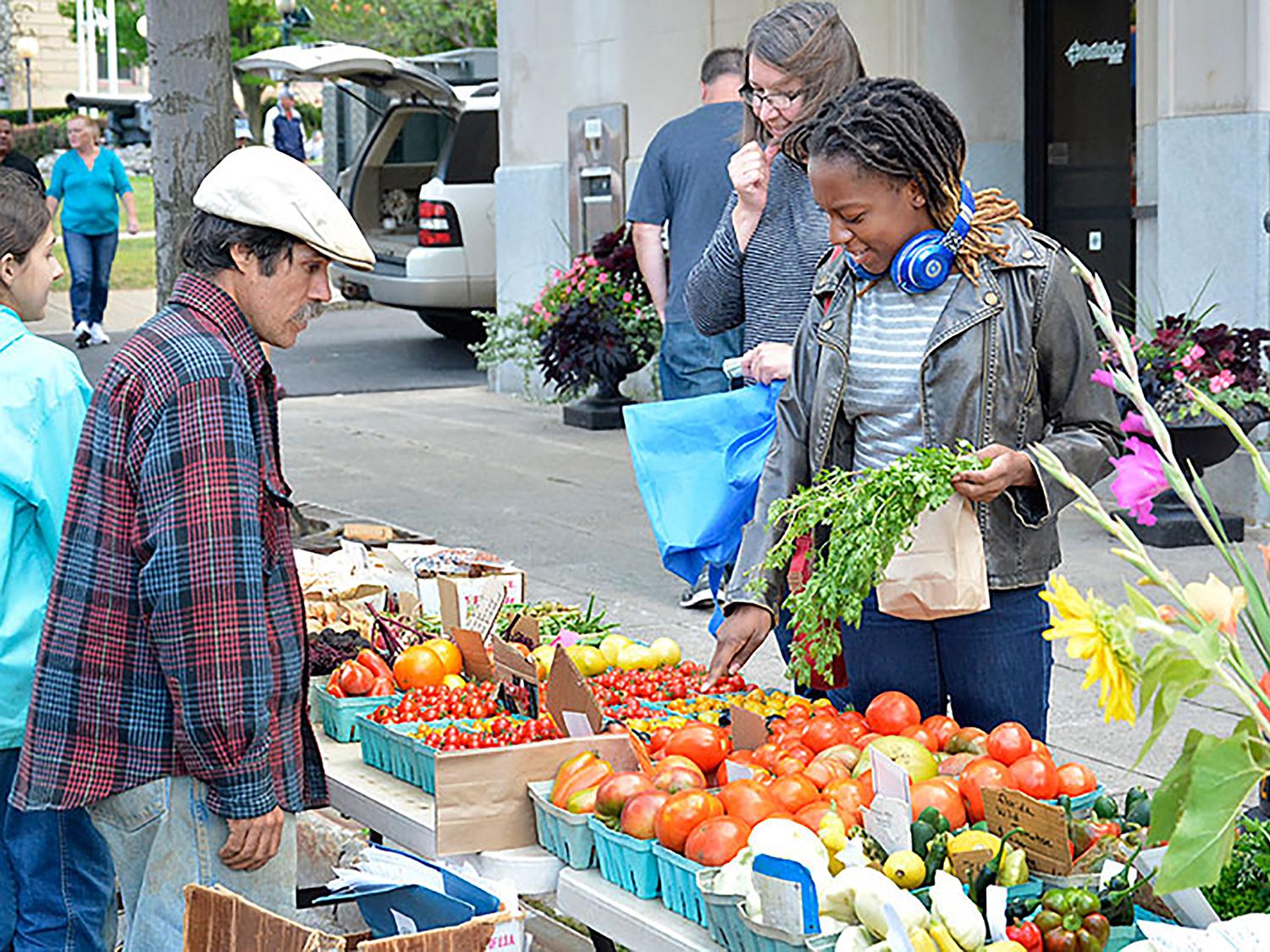 Student buys fresh goods at Farmers Market