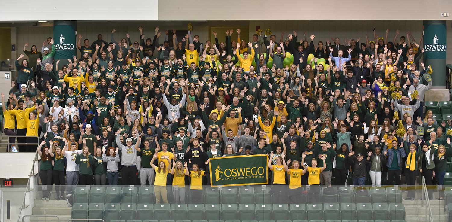 Many members of the campus community wearing green and gold