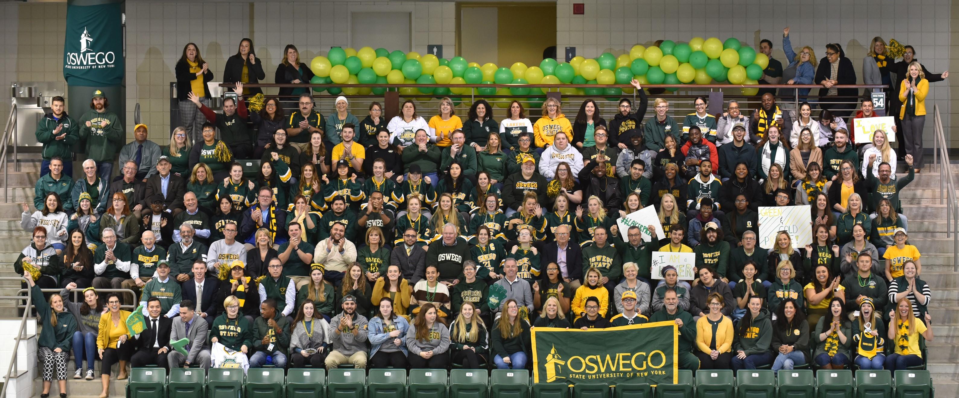 Group of students, faculty, staff and alumni in green and gold