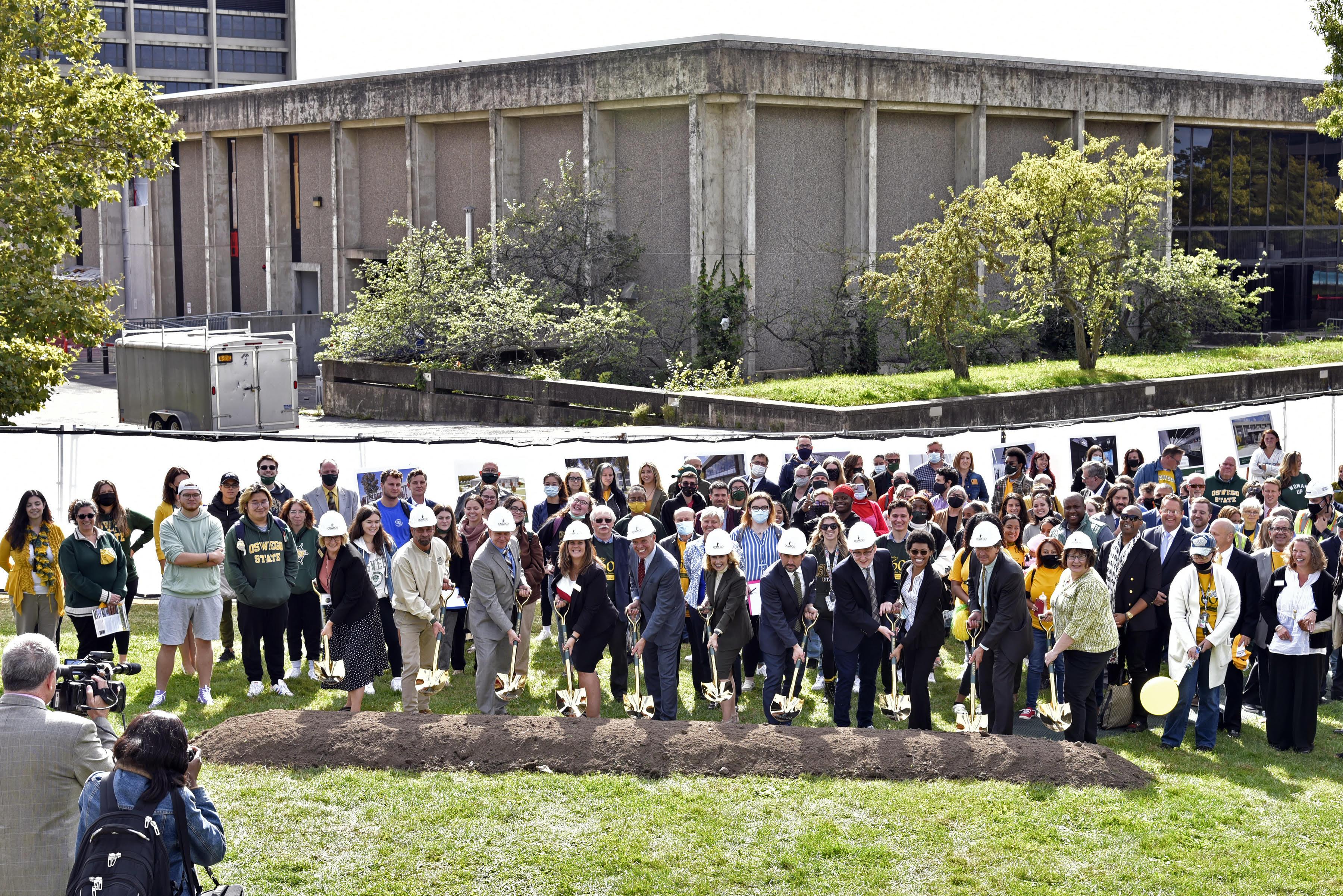 Large group with shovels and hard hats and supporters breaking ground for Hewitt renovations