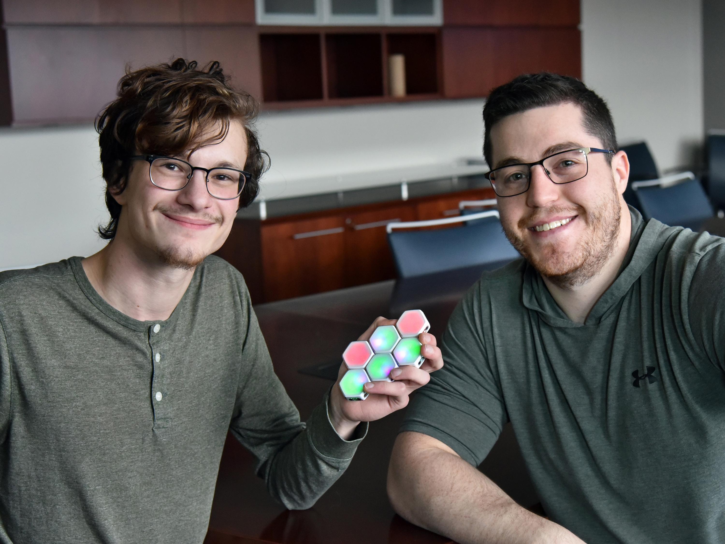 Ian Cummins and Theo Johnson with Blinks game pieces