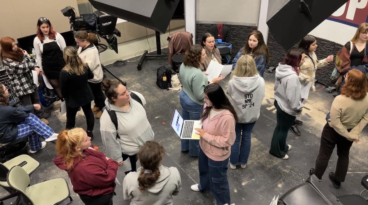 Female students a part of the first ever all-women WTOP sports broadcast speak at their pre-production meeting.