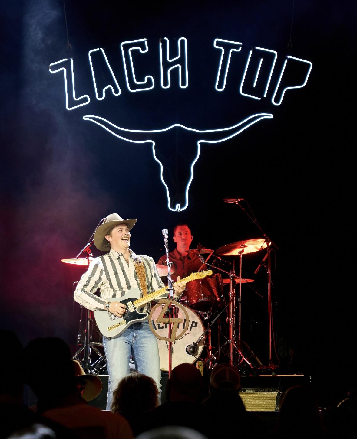 Nate Felty ’12 plays drums with country artist Zach Top at the Ryman Auditorium in Nashville, Tennessee.