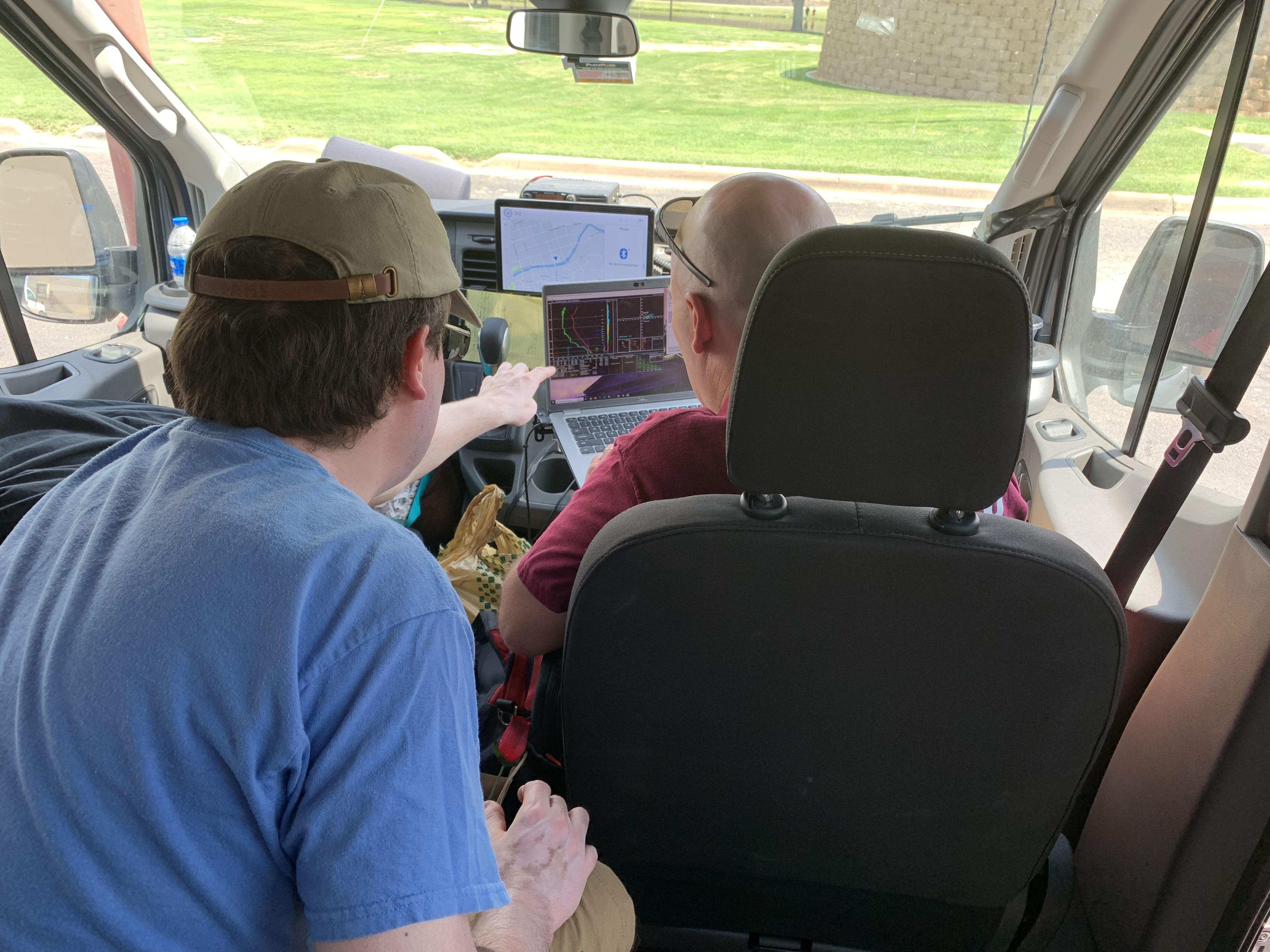 Student looking at data in the storm chasing van.