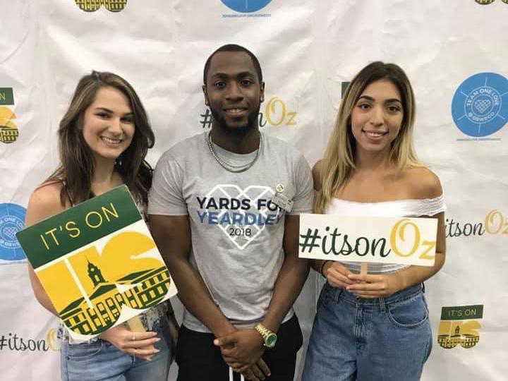 Three students show off their It's On Us T-shirts for taking the pledge to stop sexual violence