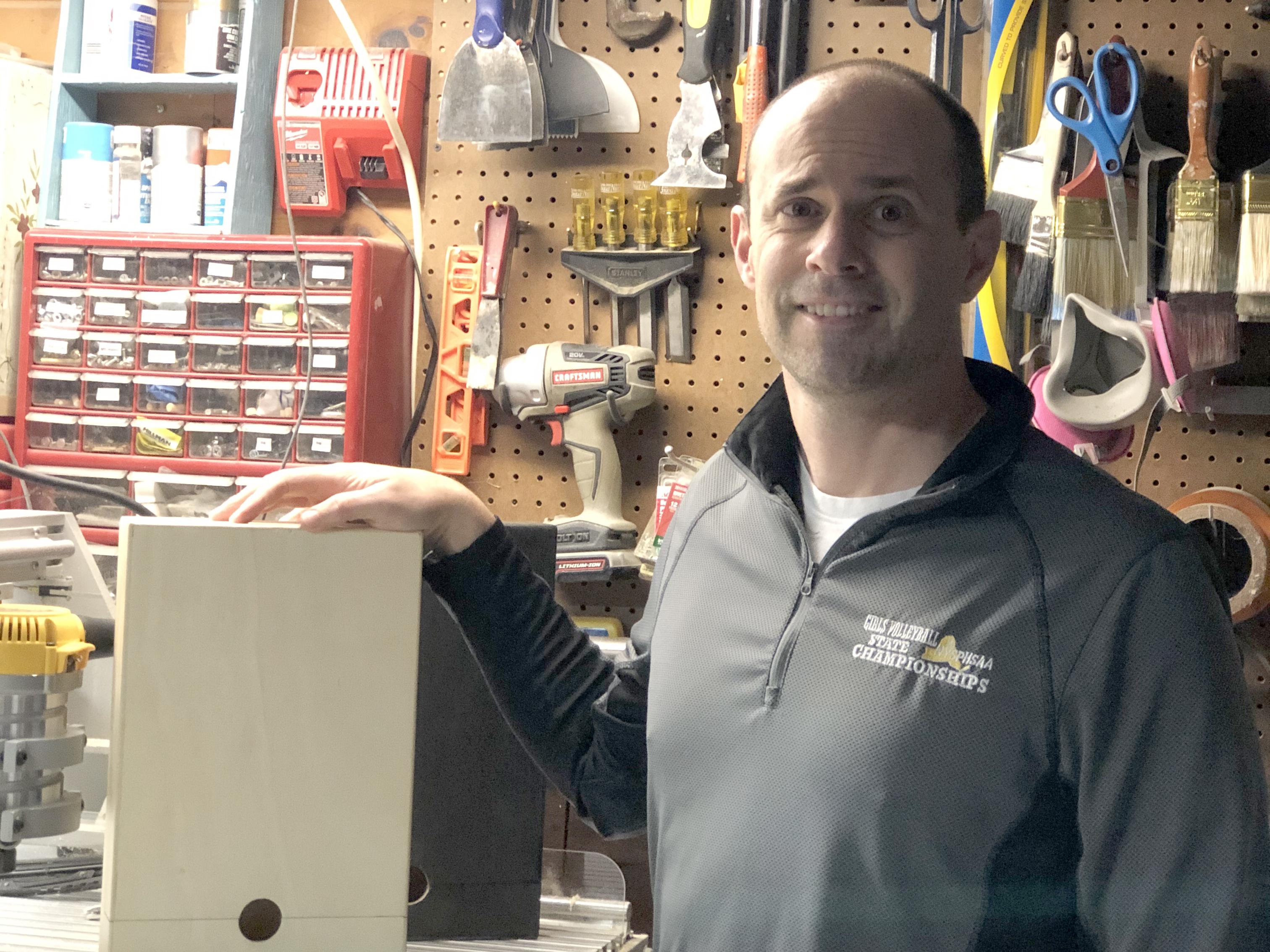 Jeff Evans, in his workshop space, shows off the wiNest, a patented idea that advanced to a statewide student business plan competition