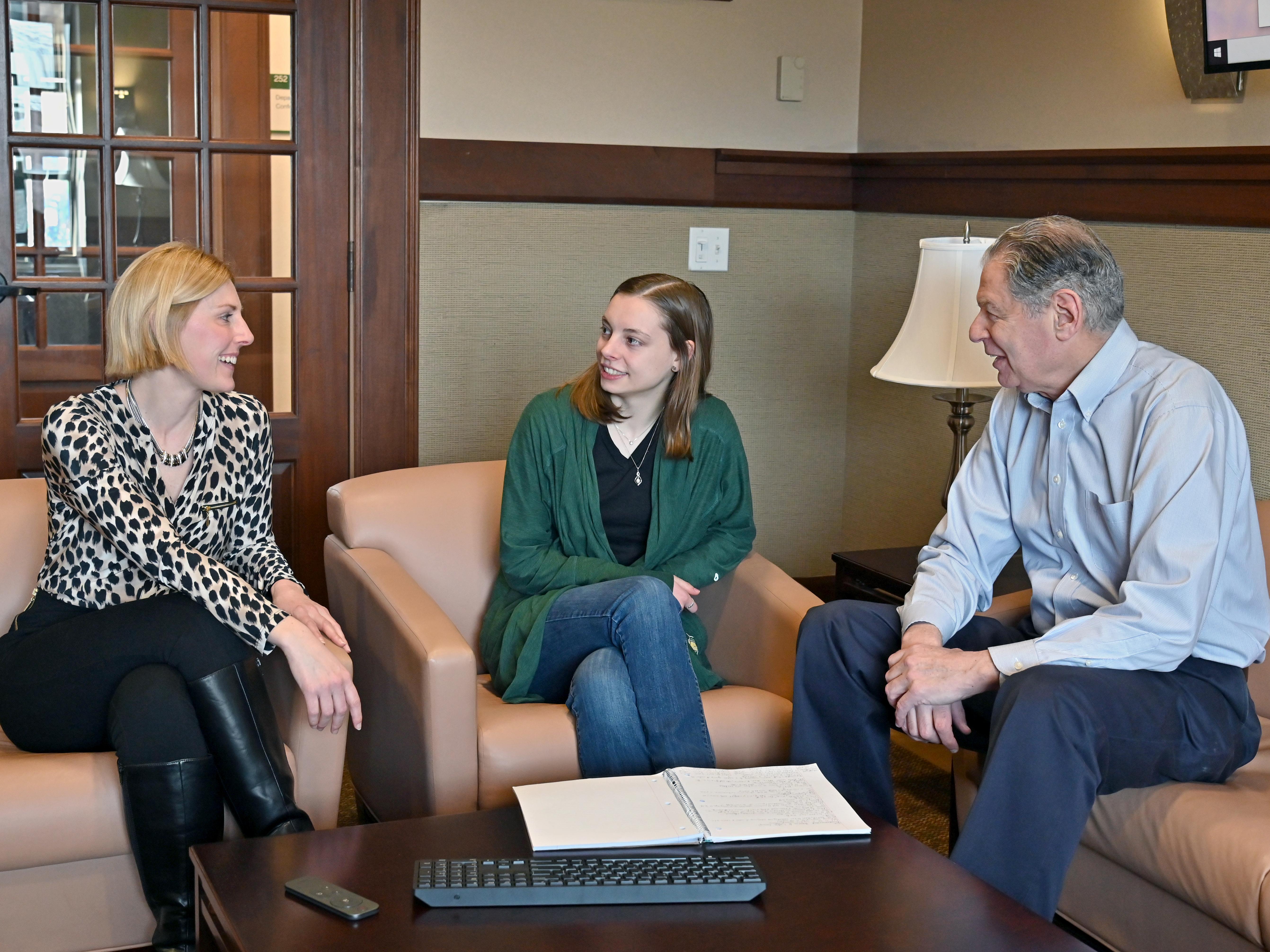  Kayla Hoyt (center), a senior human resource management major, is researching ways to mitigate and prevent microaggressions as part of her Quest research and senior honors thesis. Her advisors for the project are Kristin Sotak and Barry Friedman.