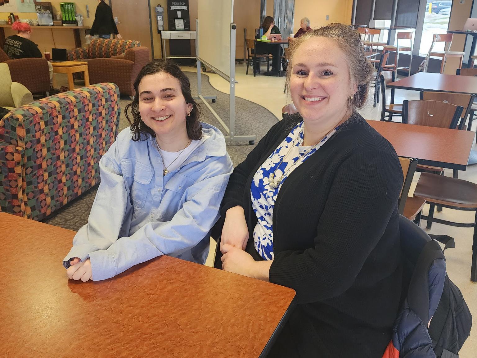 Katie Karlen, who is presenting a Quest poster promoting a better understanding of neurodiversity, meets with mentor and psychology faculty member Emily Bovier in Penfield Library's Lake Effect Cafe.