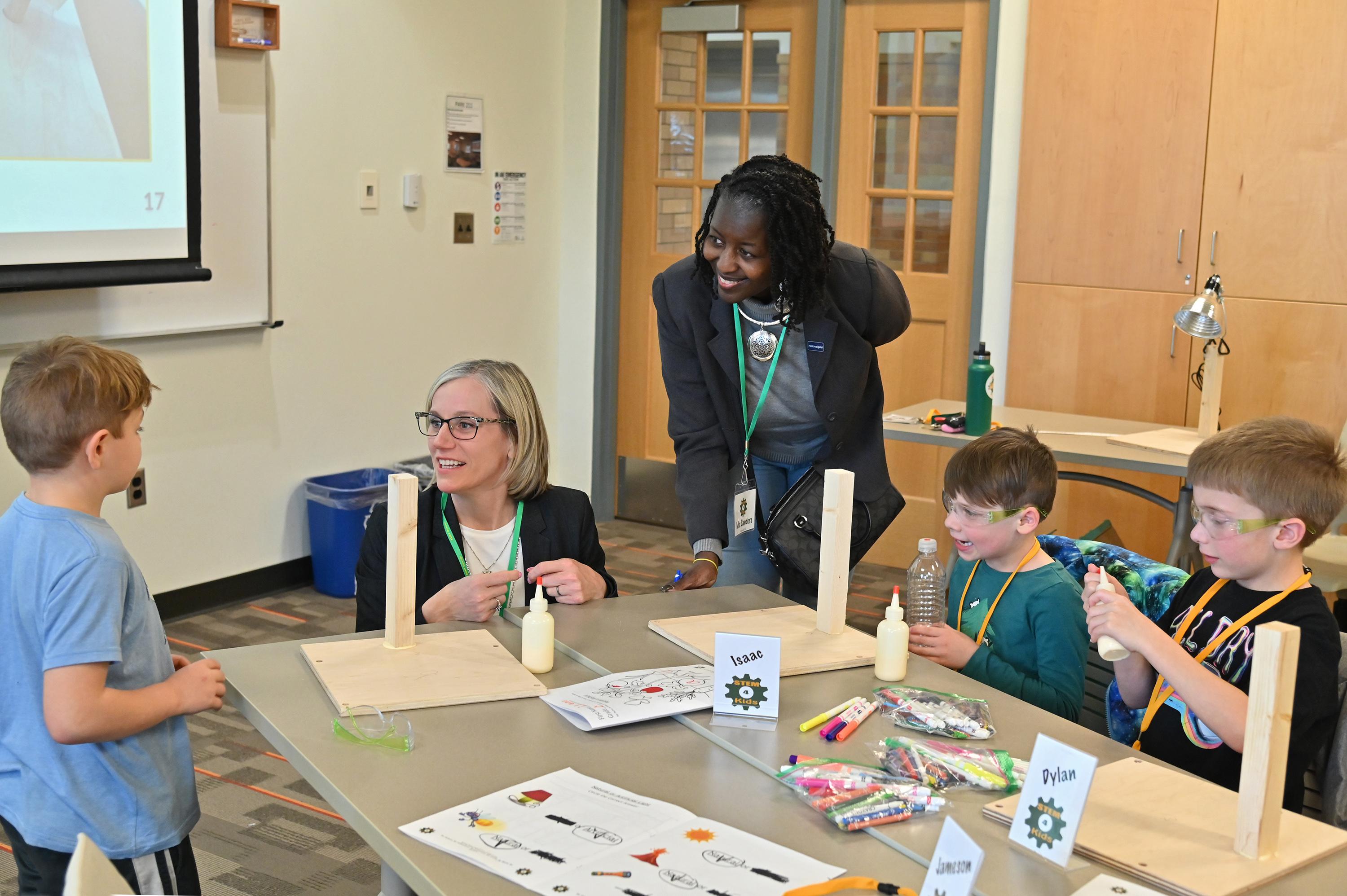Leaders from National Grid and SUNY Oswego join children in a previous KidsTech session
