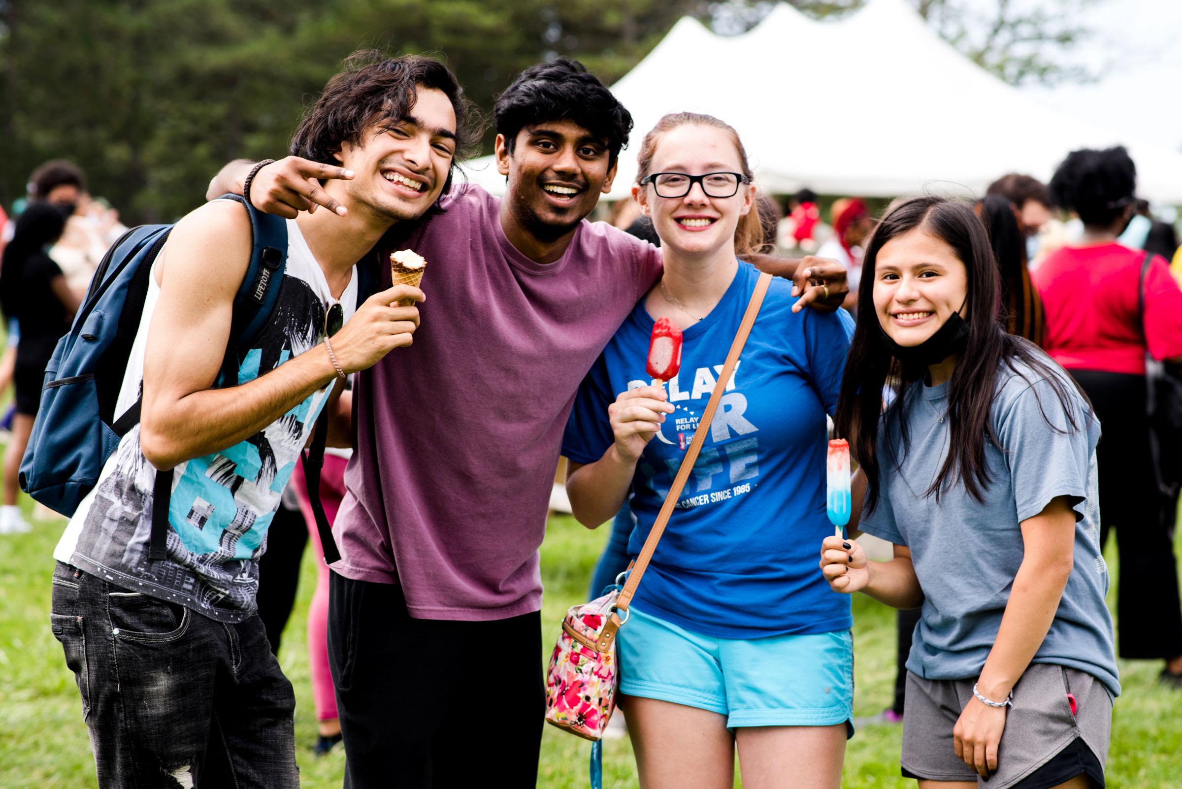 Four students pose with smiles and ice cream during 2021 LakerFest