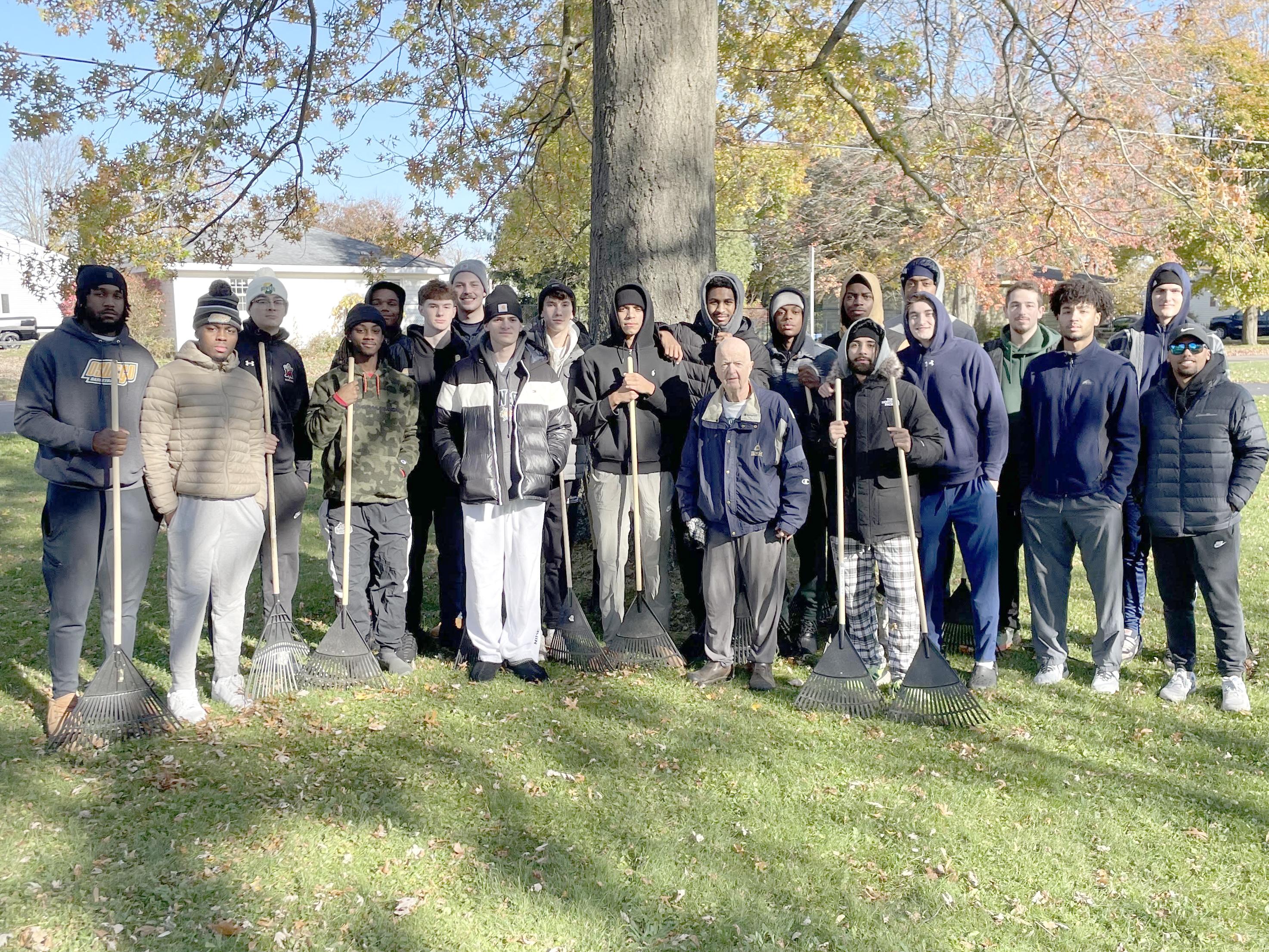 The Laker men's basketball team were among the hundreds of SUNY Oswego student-athletes raking yards for local senior citizens