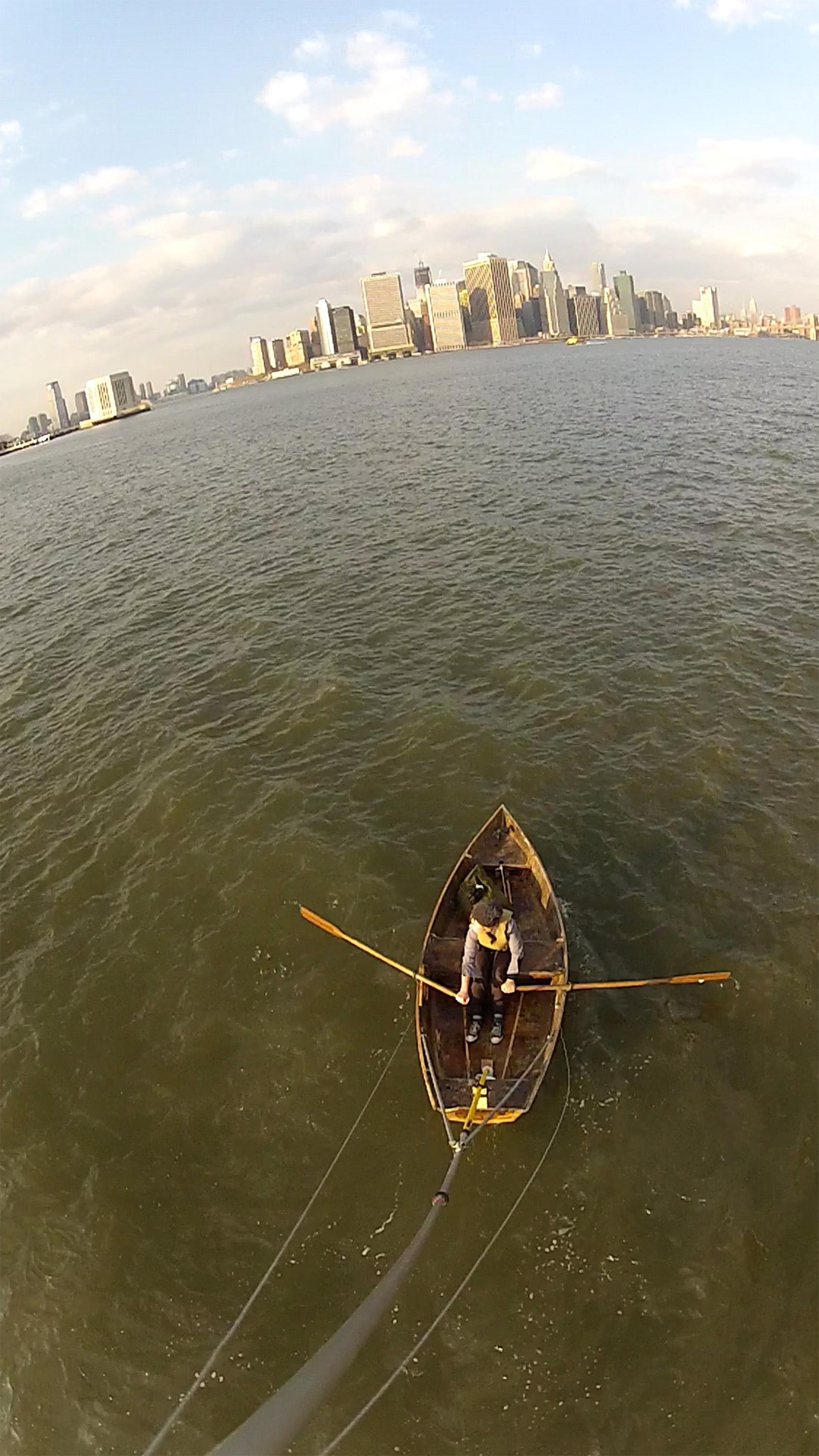 Photo of Marie Lorenz rowing a boat in New York City harbor