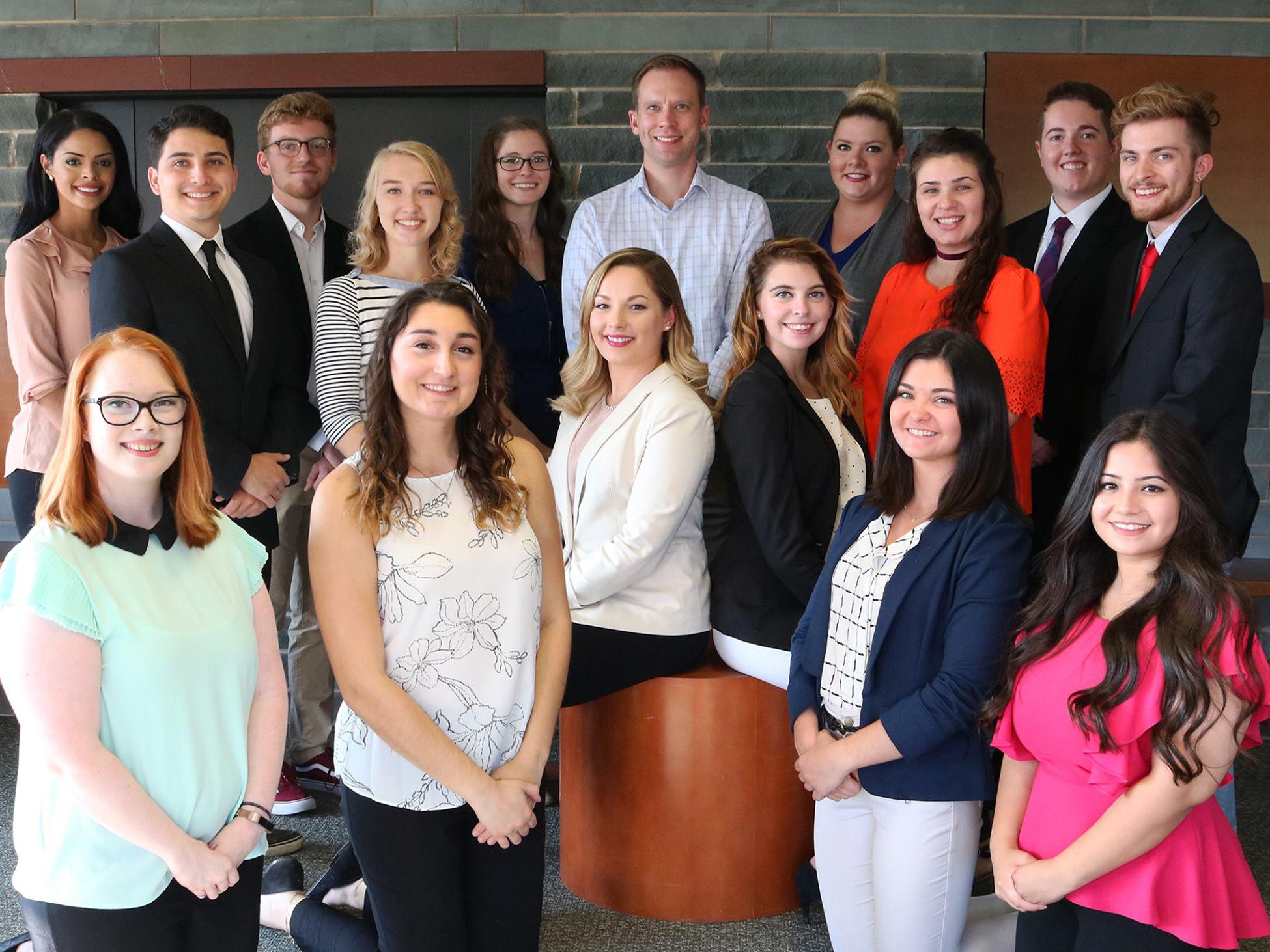 Group shot of students who organize Media Summit with adviser Michael Riecke