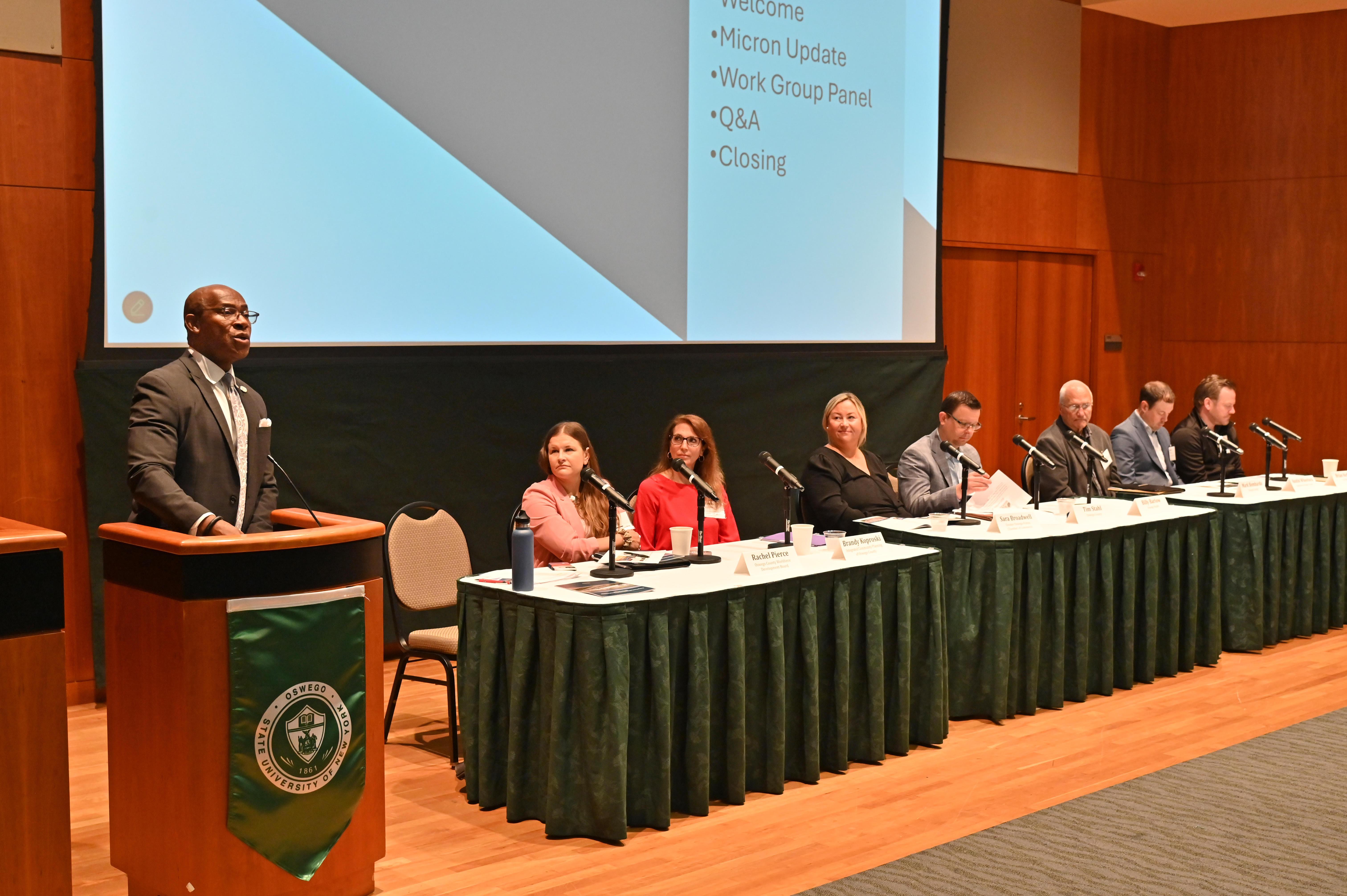 SUNY Oswego President Peter O. Nwosu (at podium) welcomes subcommittee chairs (seated) and attendees to the June 20 Oswego County Micron Strategy Steering Committee Summit