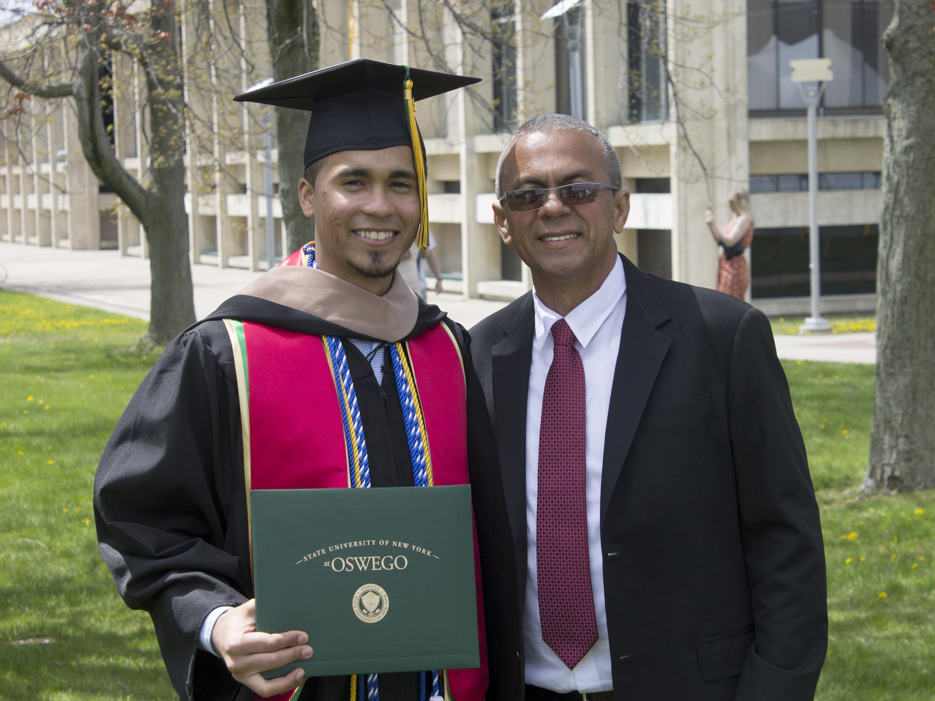 Carlos Minaya celebrates his master's degree with his father