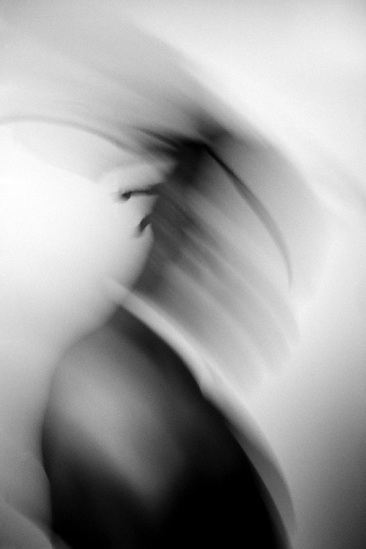 Black and white photo titled Drowning by Liam Morgenstern shows a blurred figure on a white background