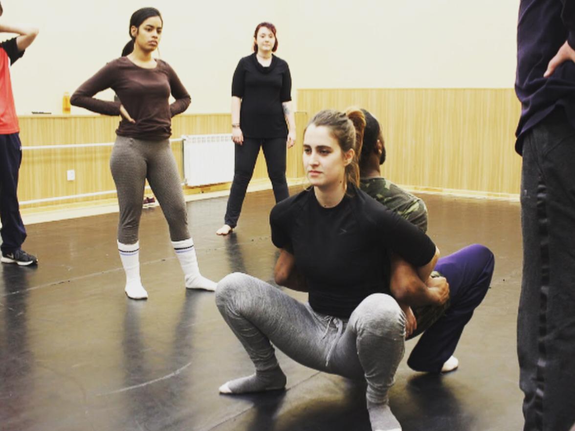 Students in a movement class learn about trust with fellow actors