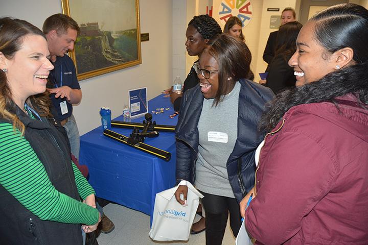 Holly Oyer, National Grid director of gas field operations in Central New York, talks with SUNY Oswego students Taylor Clark and Kariya Buckshot