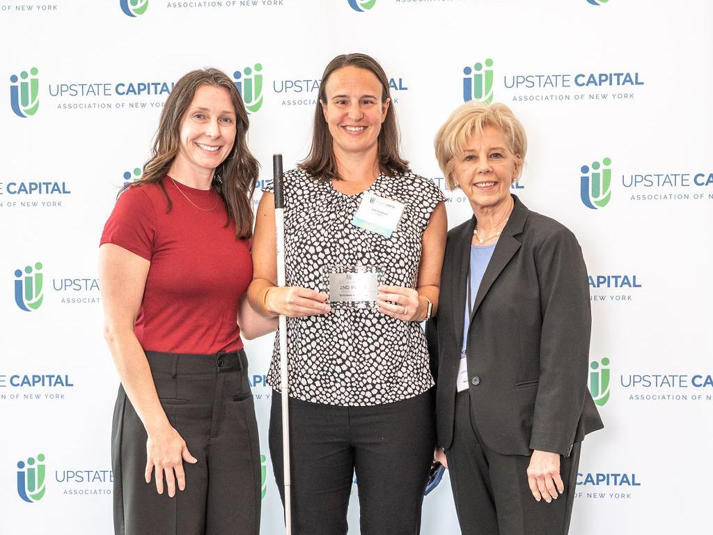 Erin Czadzeck (center), a student in Oswego's online MBA program, is honored for placing second in her division in the New York State Business Plan competition, flanked by Sarah Bonzo (left) and Irene Scruton