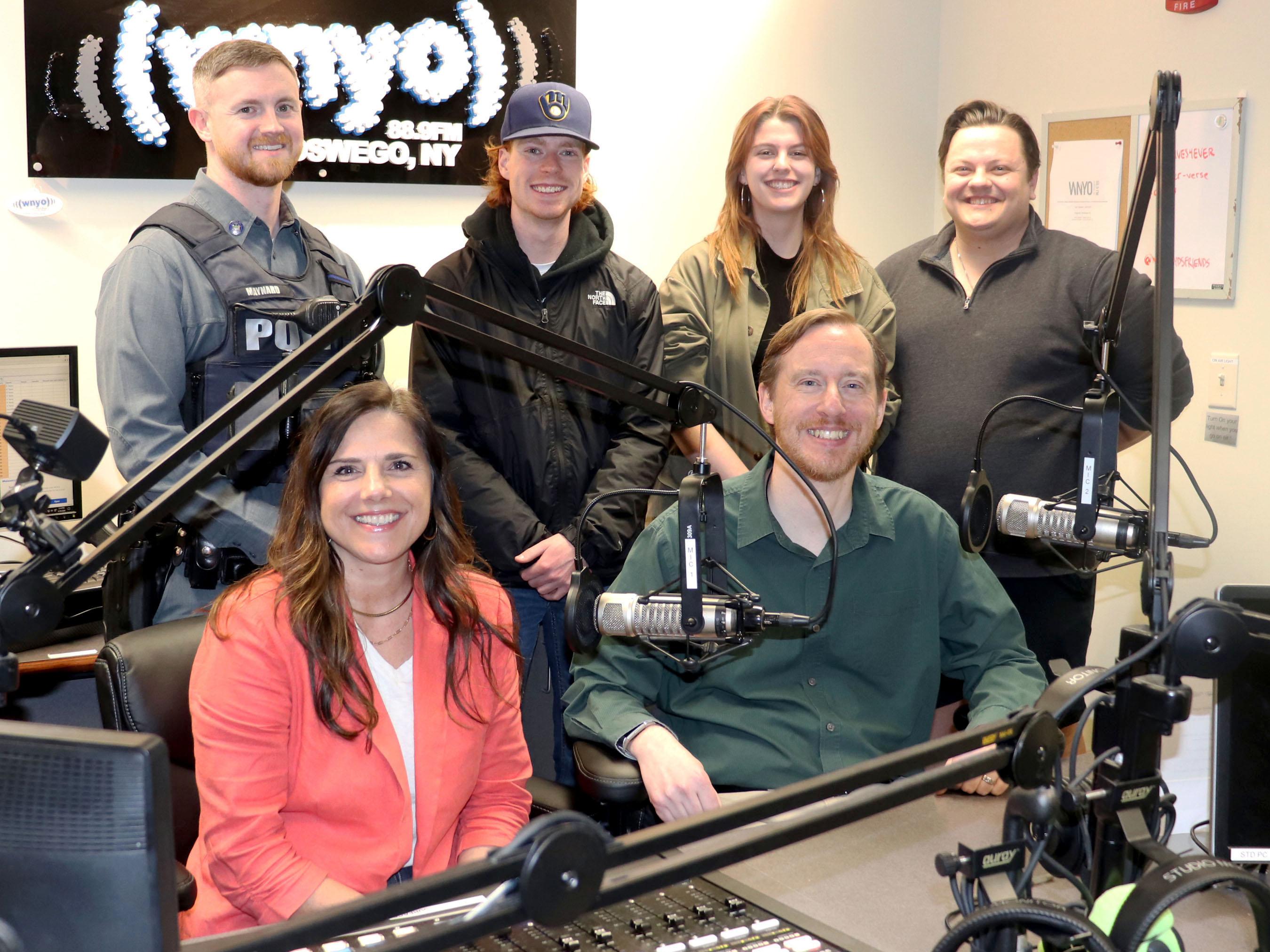 Representatives of WNYO radio, Oswego County Opportunities and University Police gather to prepare for the second 24-hour Radiothon