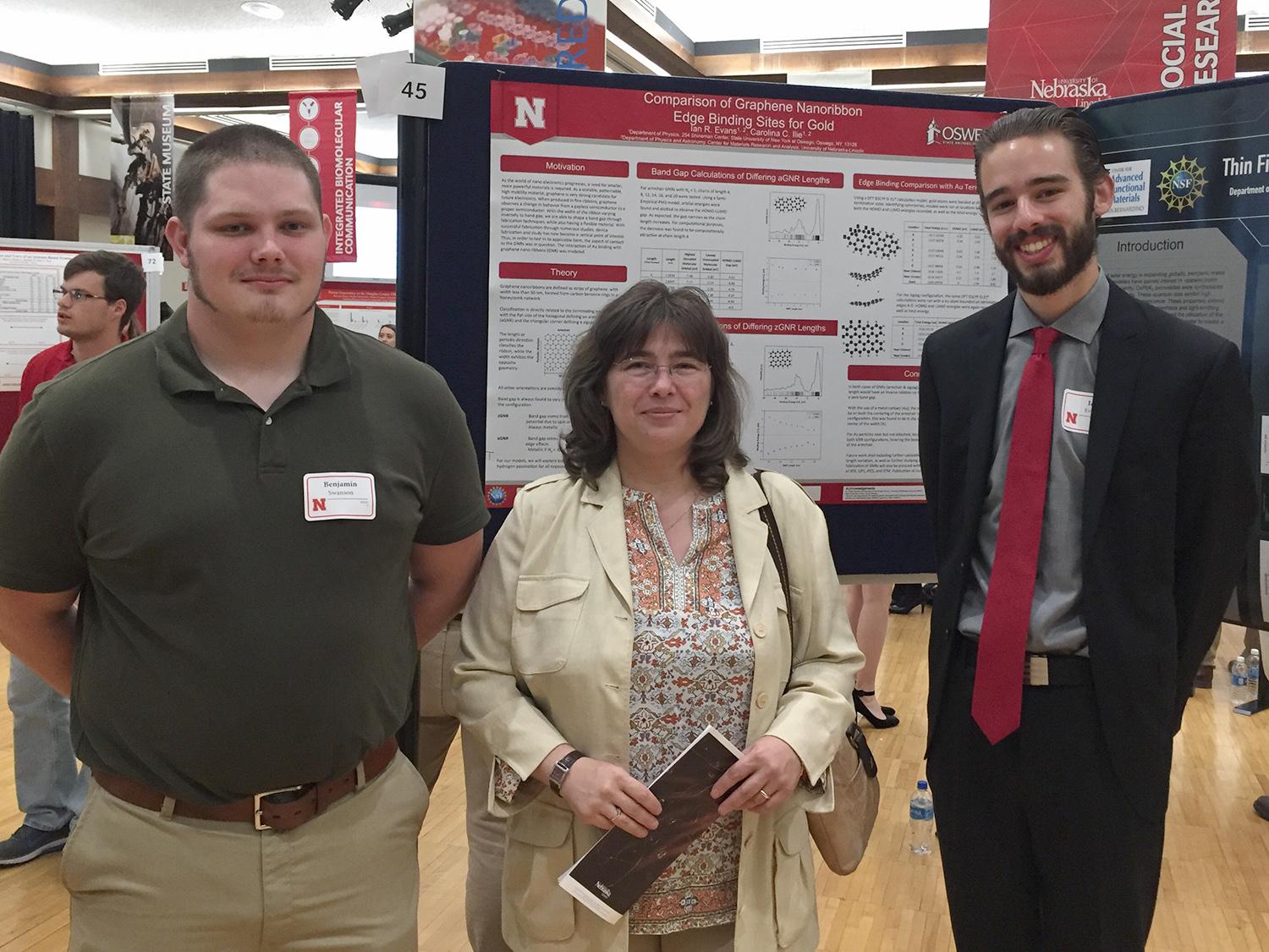 Benjamin Swanson, Carolie Ilie and Ian Evans with research poster