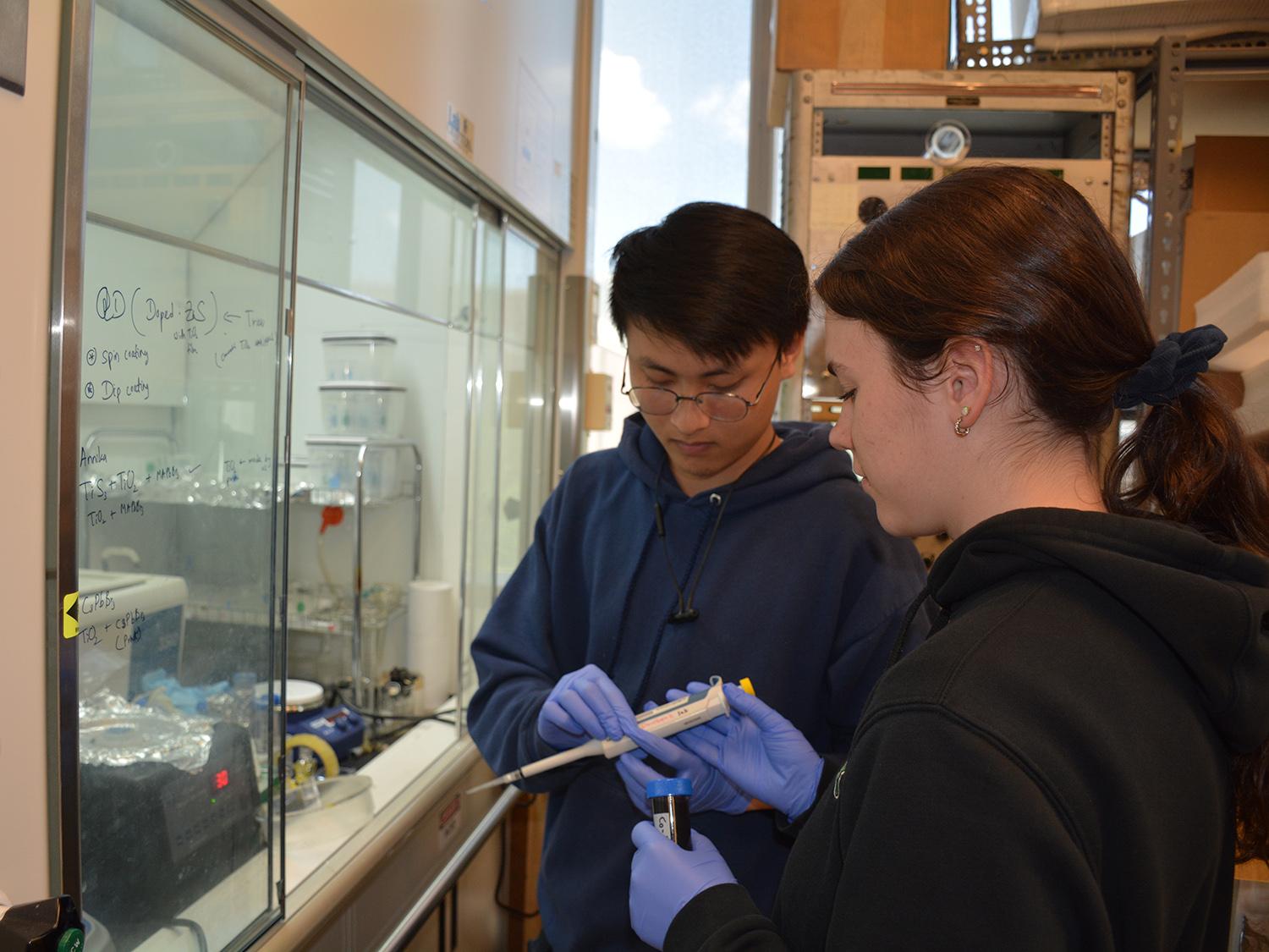 Physics undergraduates Trieu Le and Annika Neufeld-Kreider conducting research