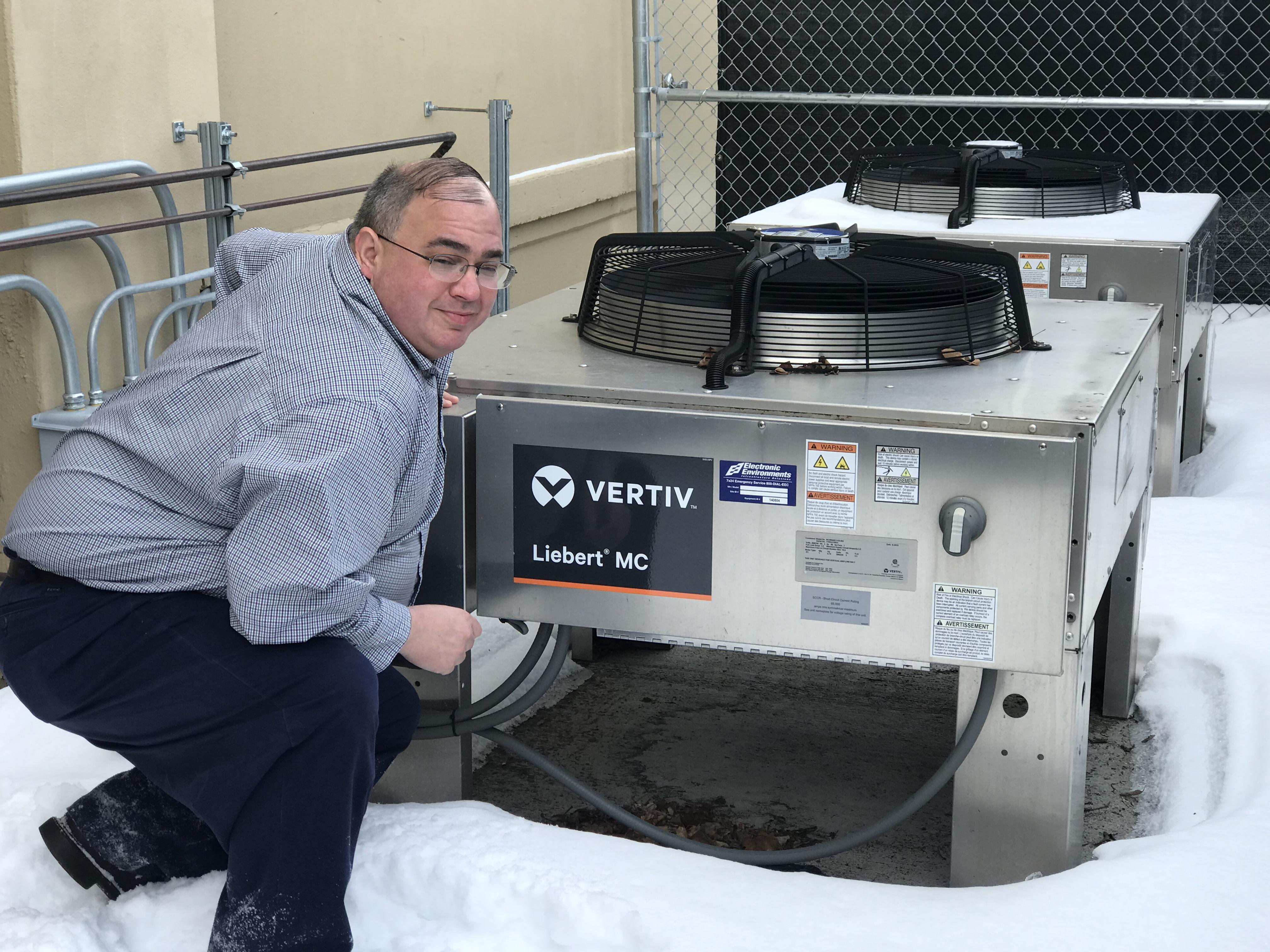 Joe Pompeii, a senior project manager for Stark Tech, with an air conditioning unit