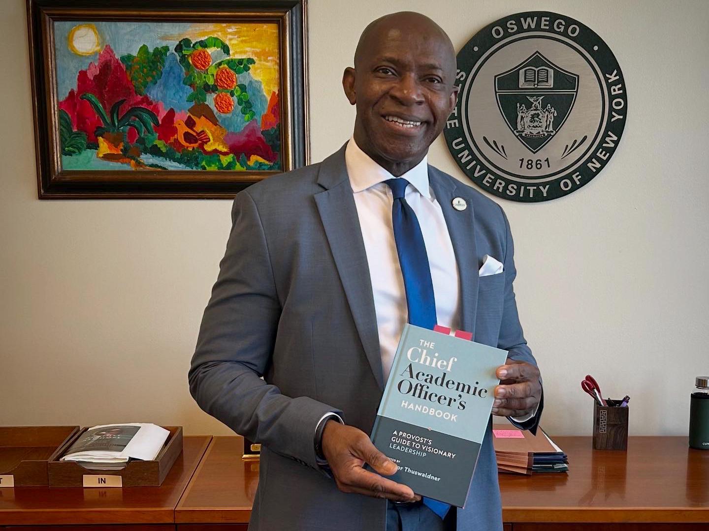 President Peter O. Nwosu with book he contributed two chapters to