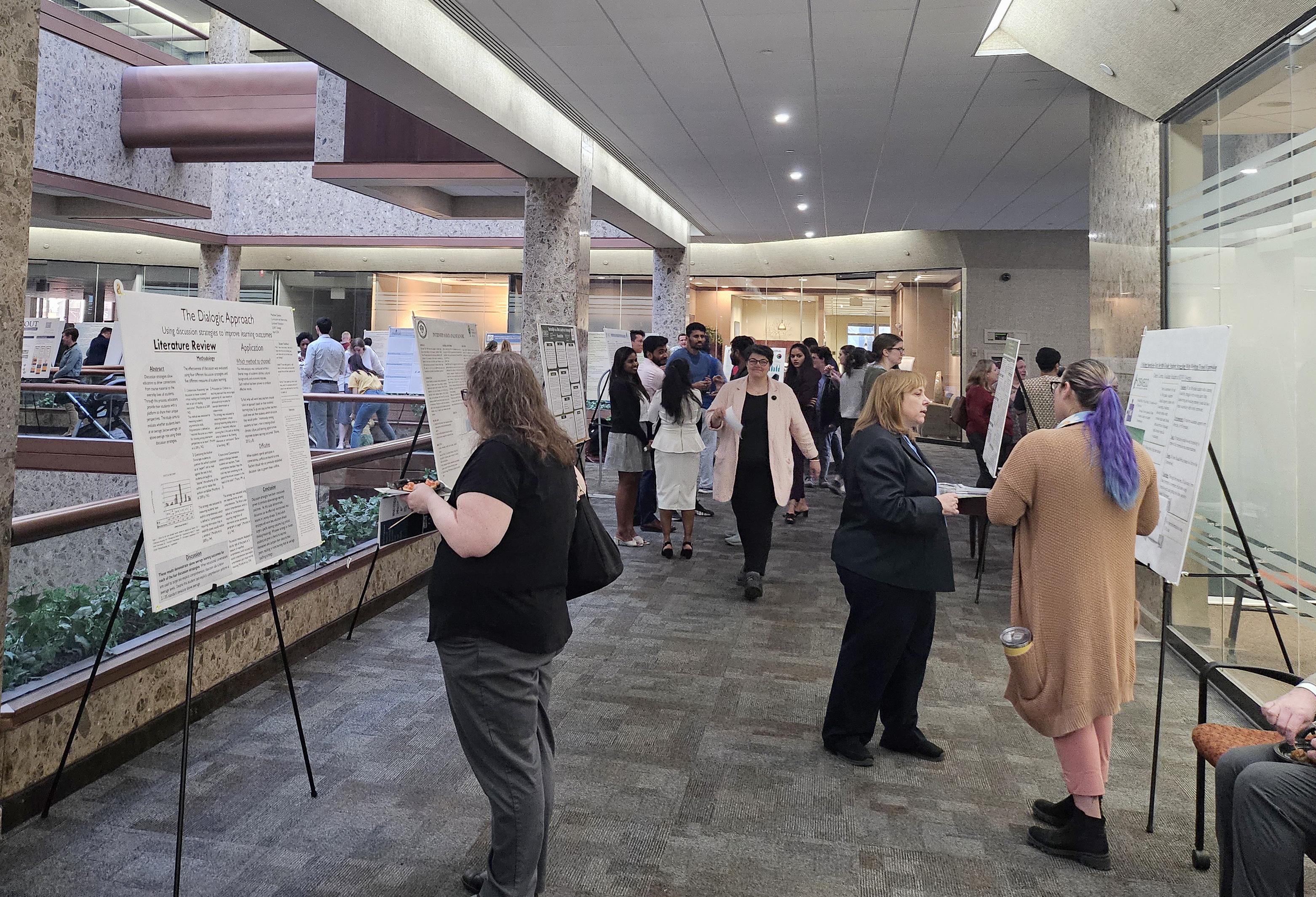People check out poster presentations at the Syracuse Campus' Quest 2024 display
