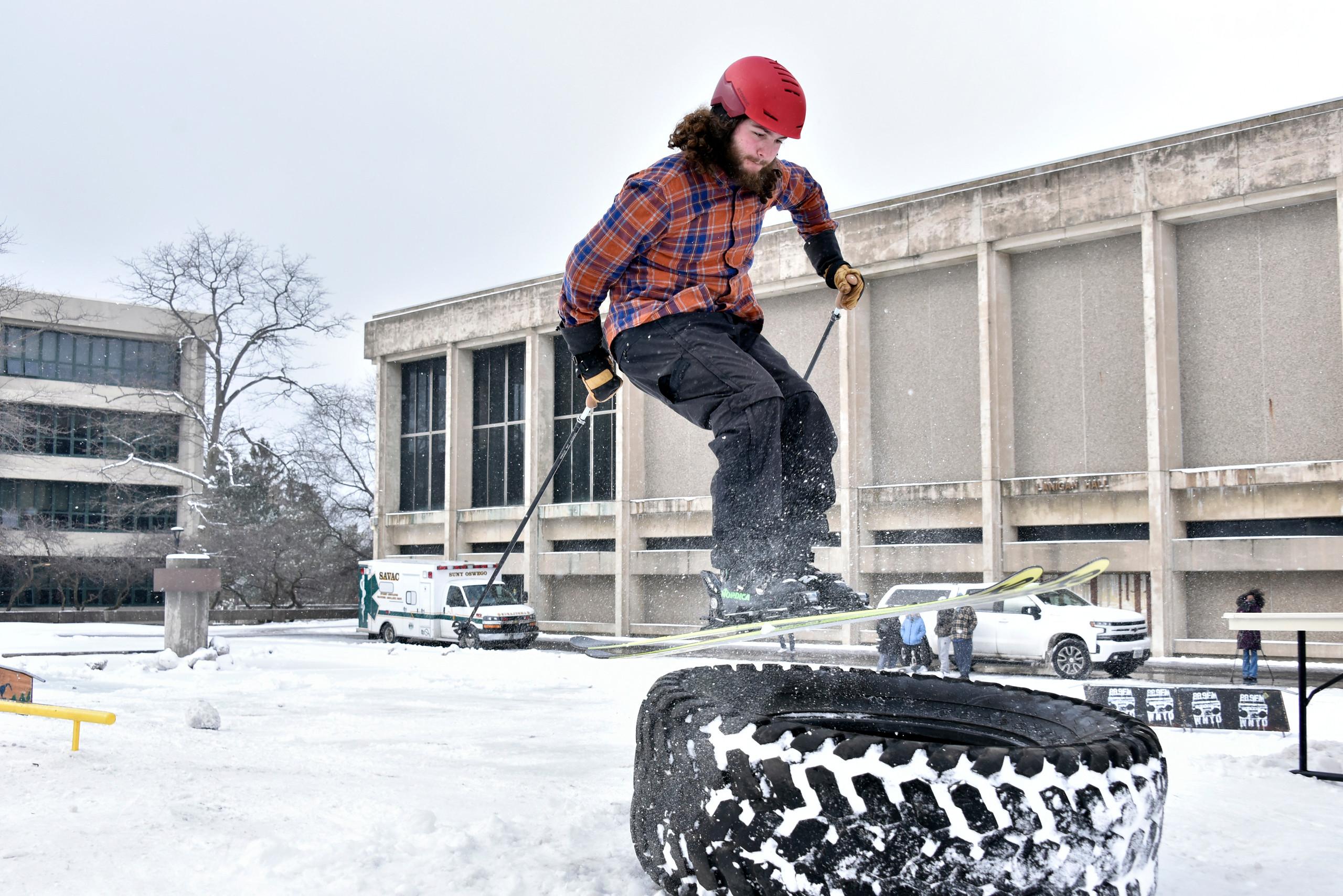 A skier jumps onto a large tire during a previous Rail Jam event