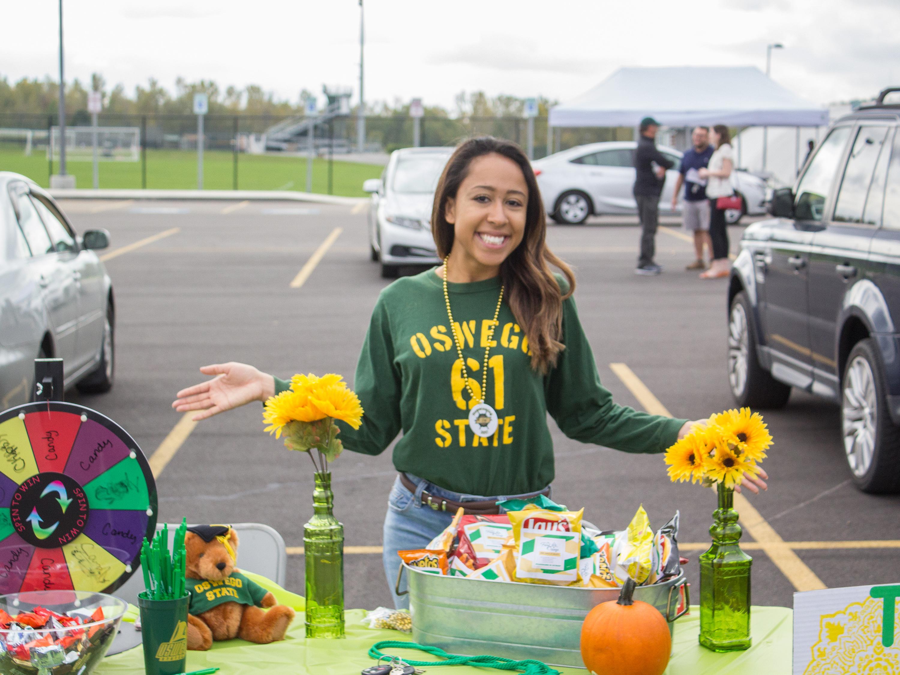 Student staffs a table at Homecoming