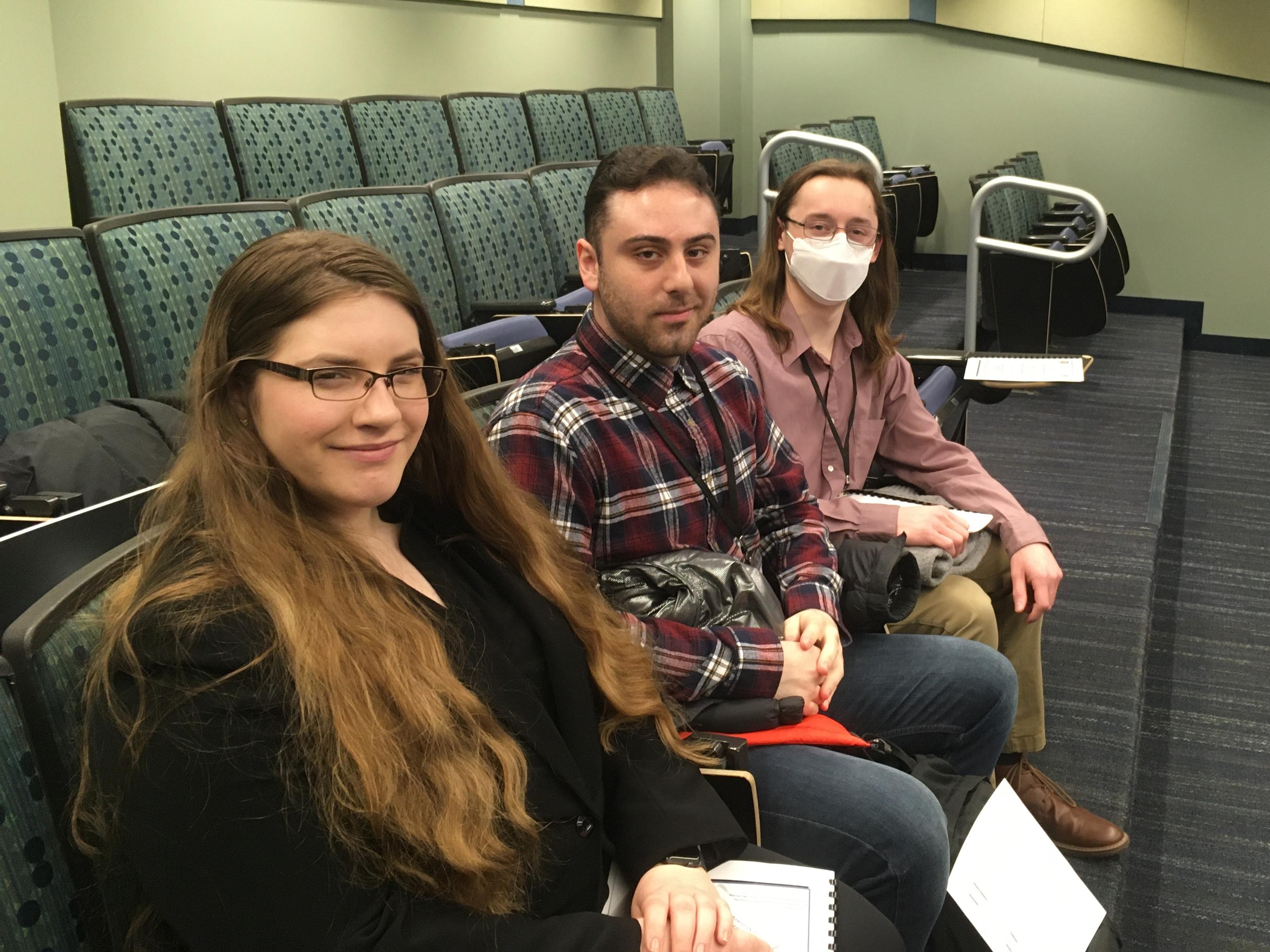 Lauren Samson, Michele Manno and Hugh Riley Randall sit in classroom during the Rochester Symposium for Physics