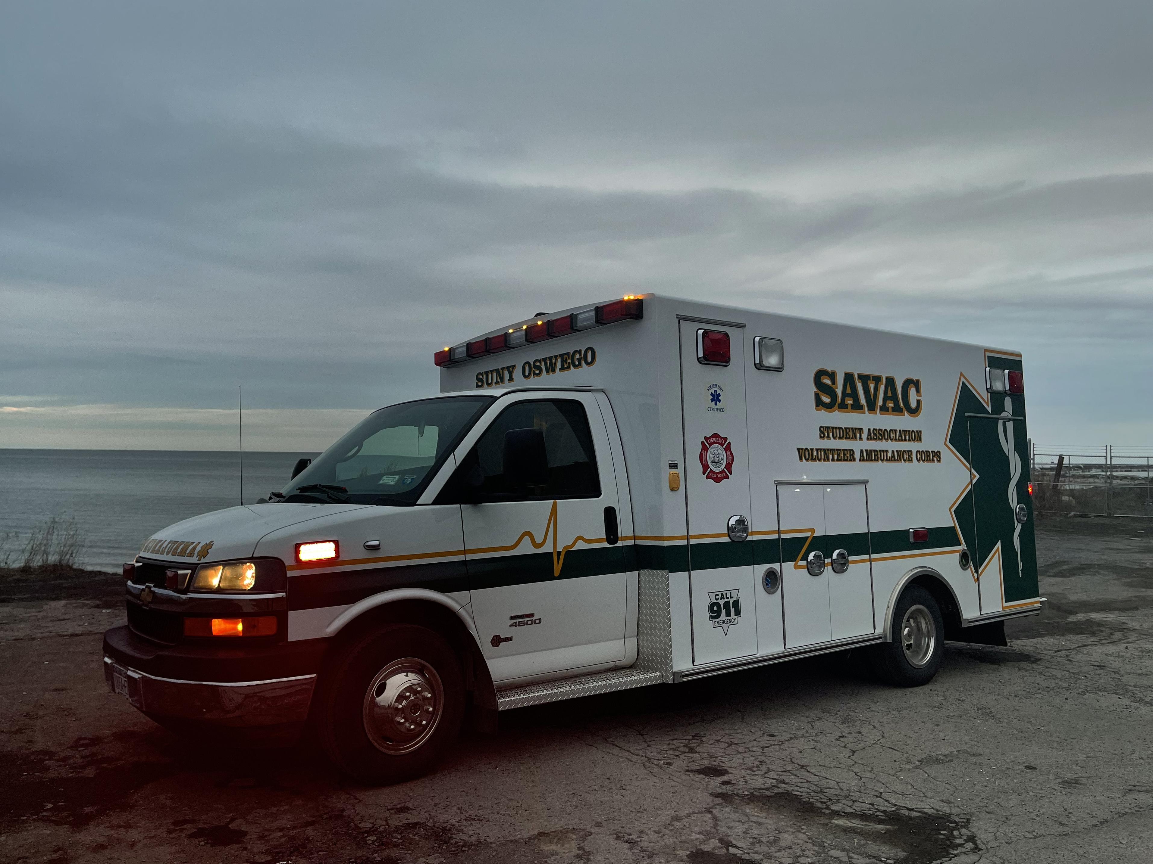 Photo of SAVAC ambulance on lakeshore at sunset