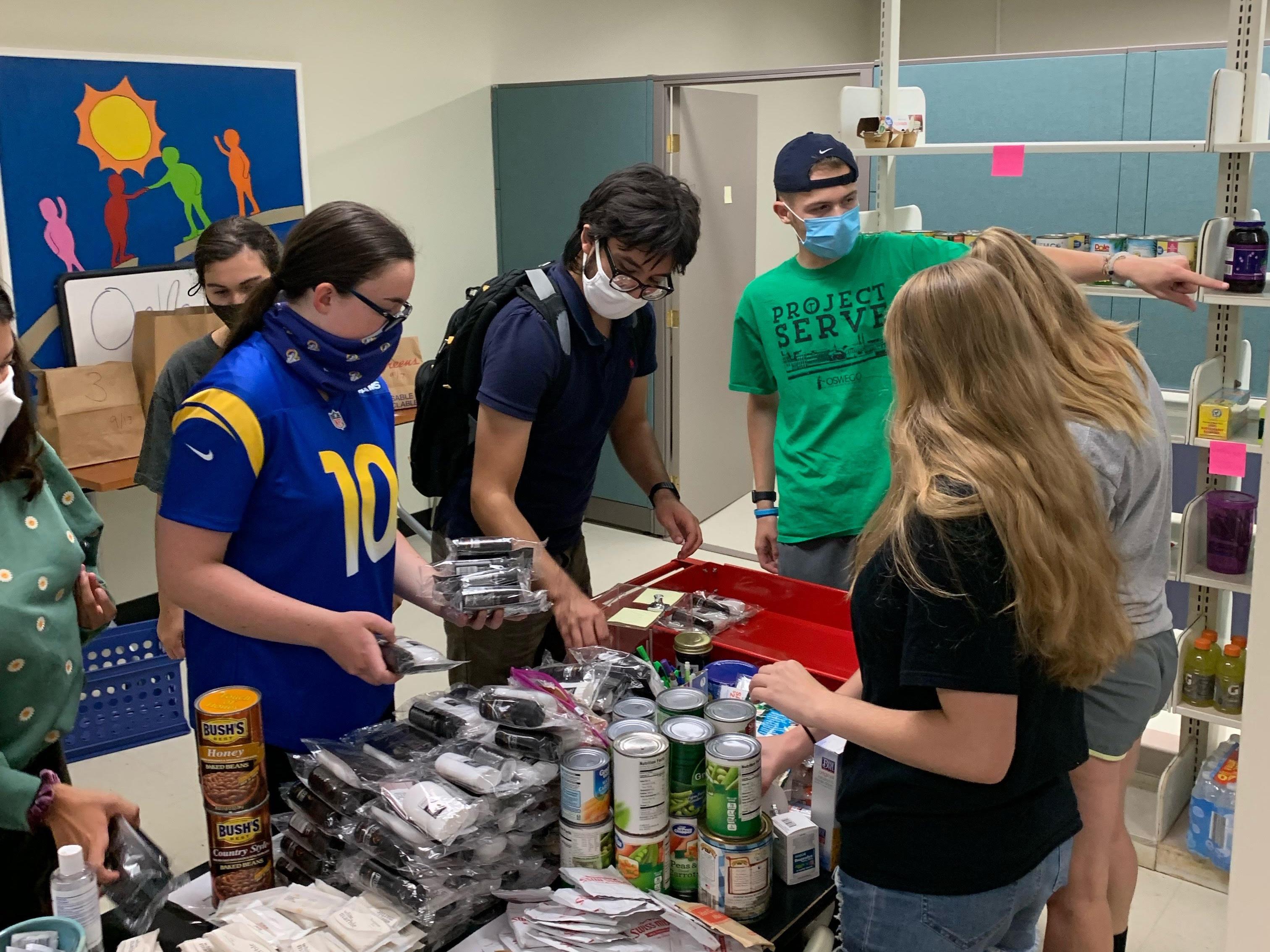 Student volunteers help take inventory of stock for the SHOP food pantry