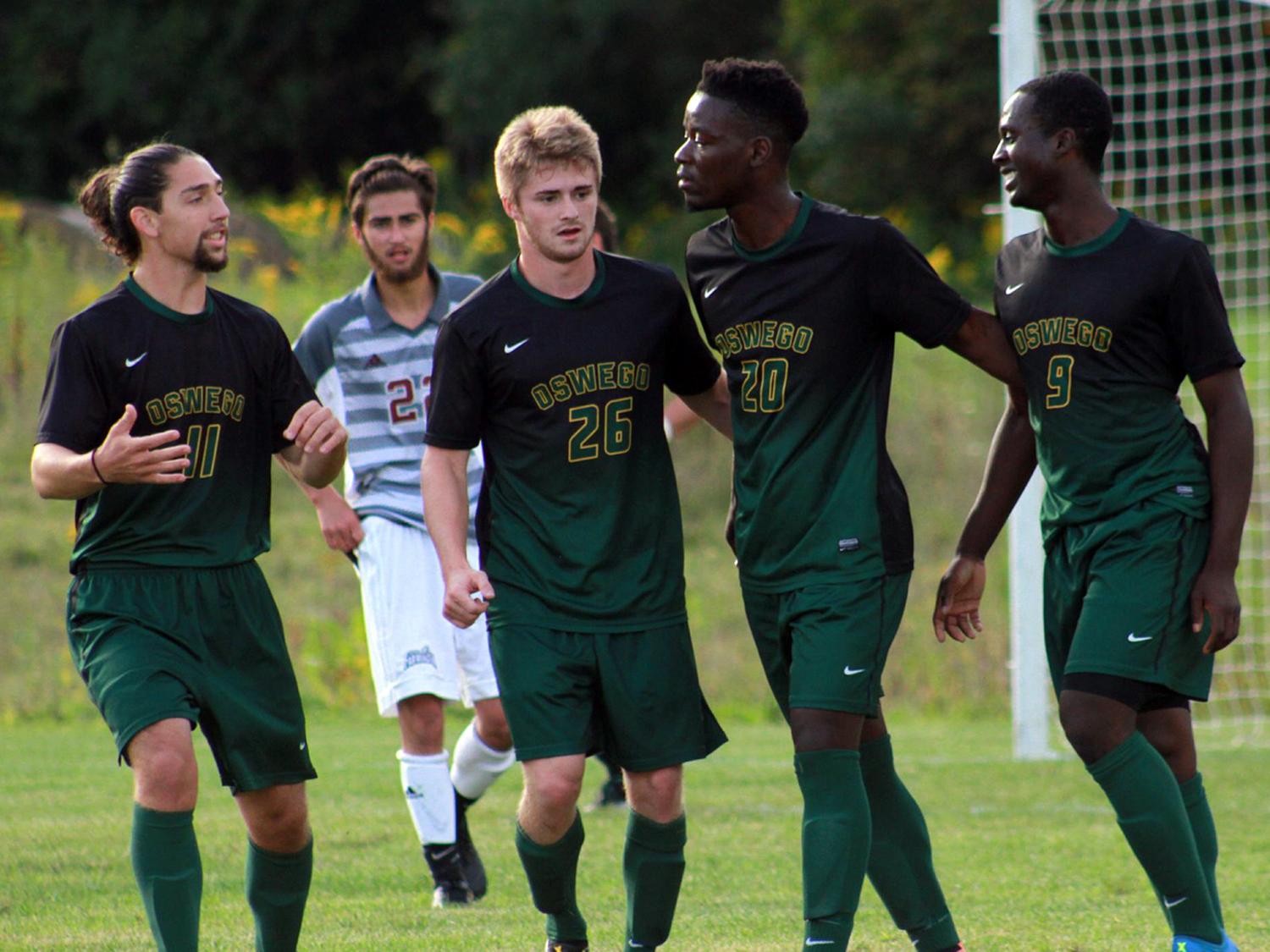 Laker men's soccer players congratulate each other