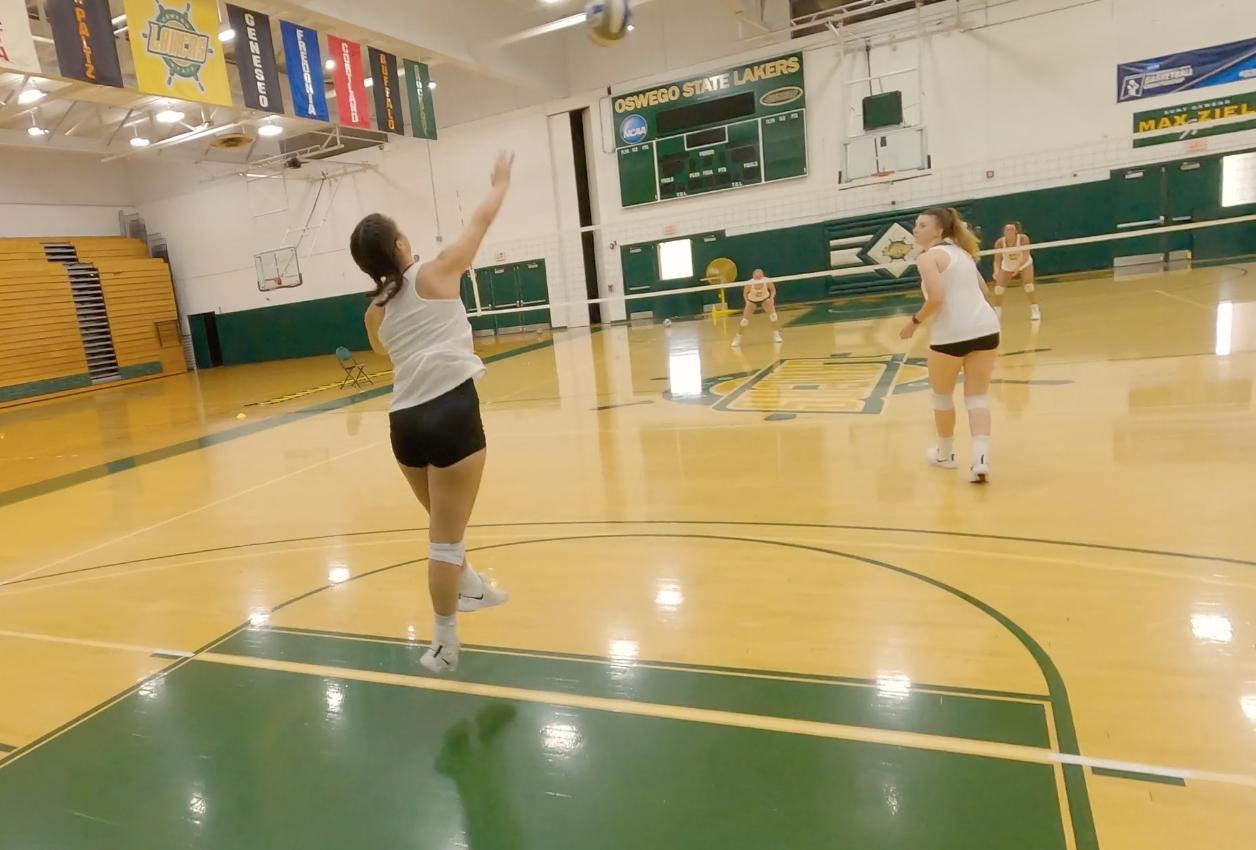 Skylar Bechard serves in a volleyball practice