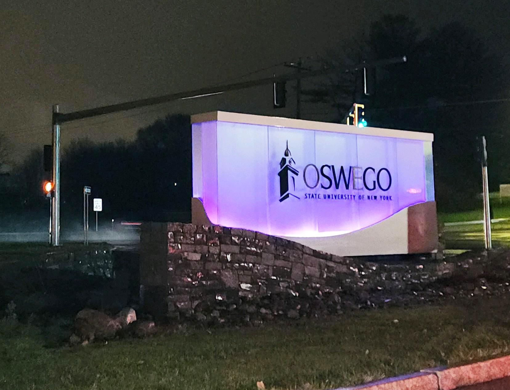 SUNY Oswego sign lit up in purple to recognize World Pancreatic Cancer Day