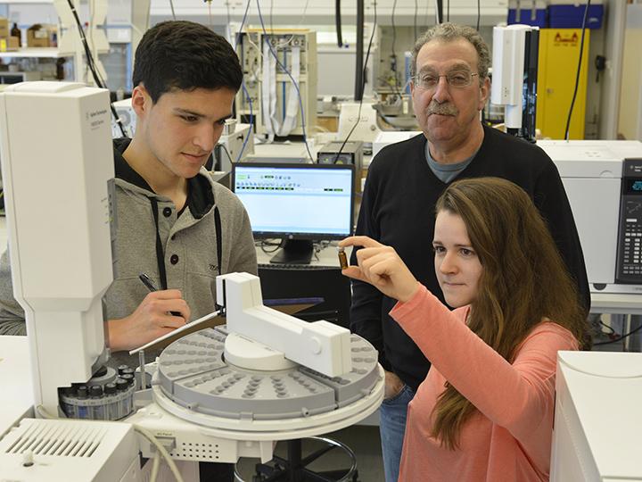 Students conduct research while a faculty supervises