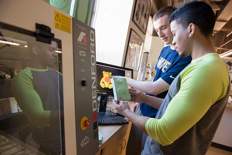 Two students using 3-D printer