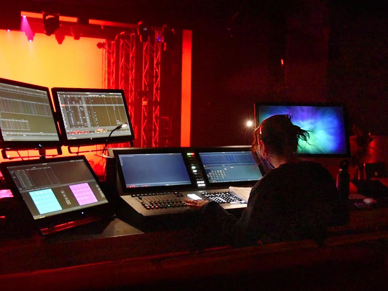 Alaina Herman, a sophomore theatre technology major, controlling the stage lighting during a test run of Going Mad in Wonderland