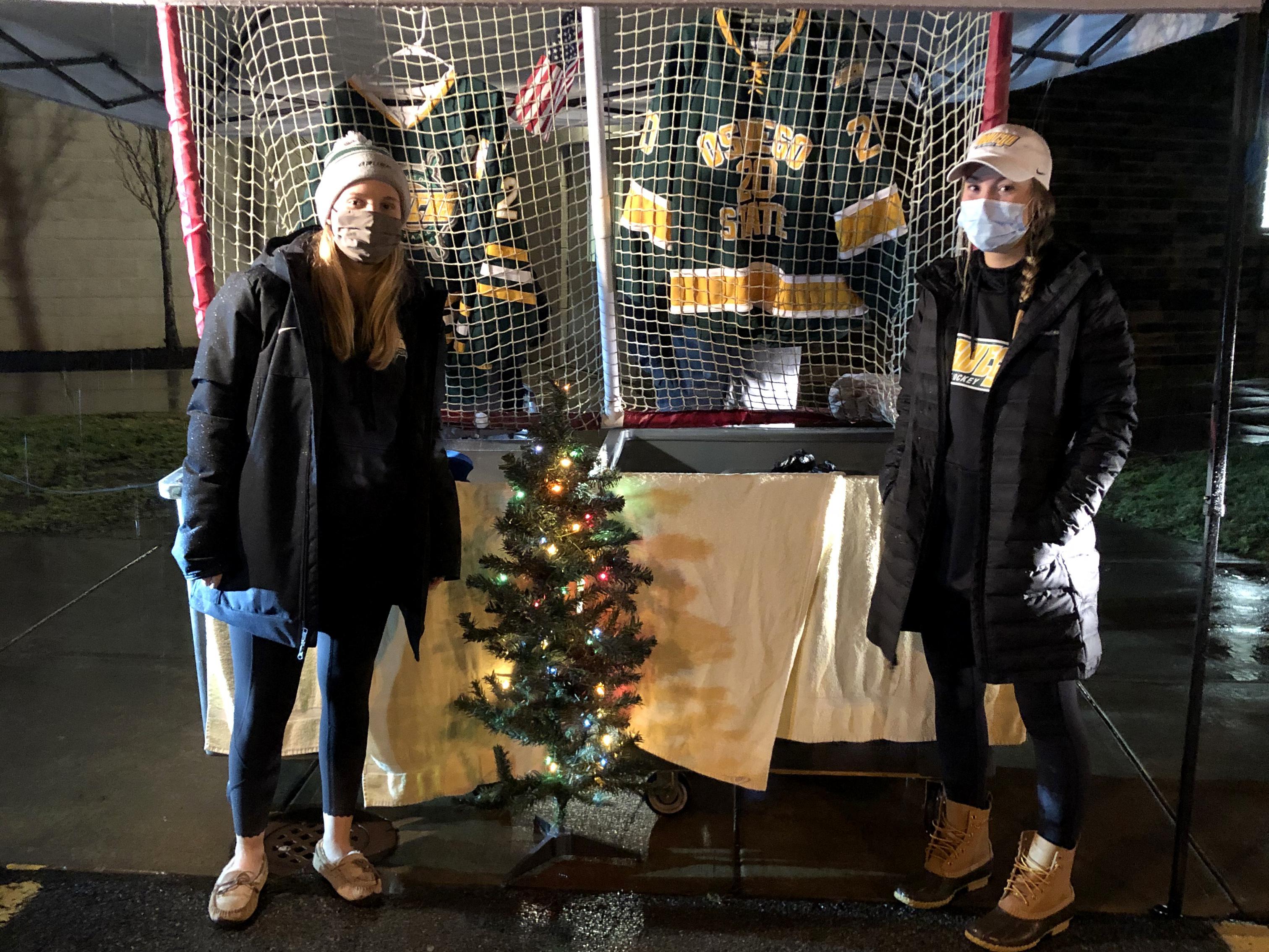 Laker women's hockey players help collect stuffed animals for the drive-through Teddy Bear Toss