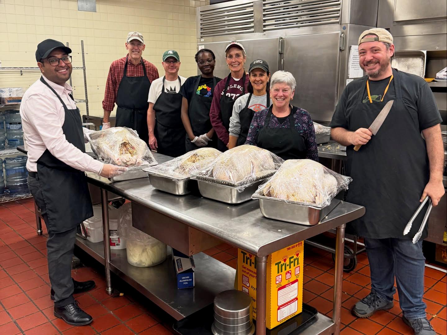 Volunteers gather in the kitchen during preparation for SUNY Oswego's Thanksgiving meal