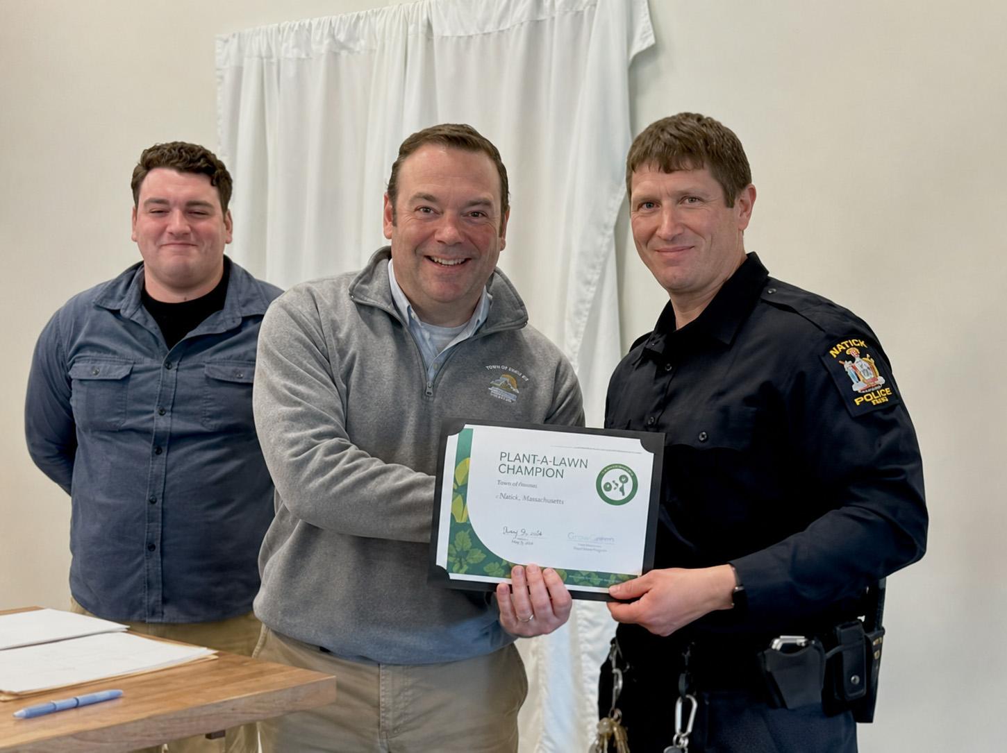 University Police Officer Jacob Lyon (right) receives the 2026 Traffic Safety Champion award from the Oswego County Traffic Safety Council via University Police Chief Scott Swayze (center) and Gavin Wandersee, Oswego County coordinator of traffic safety