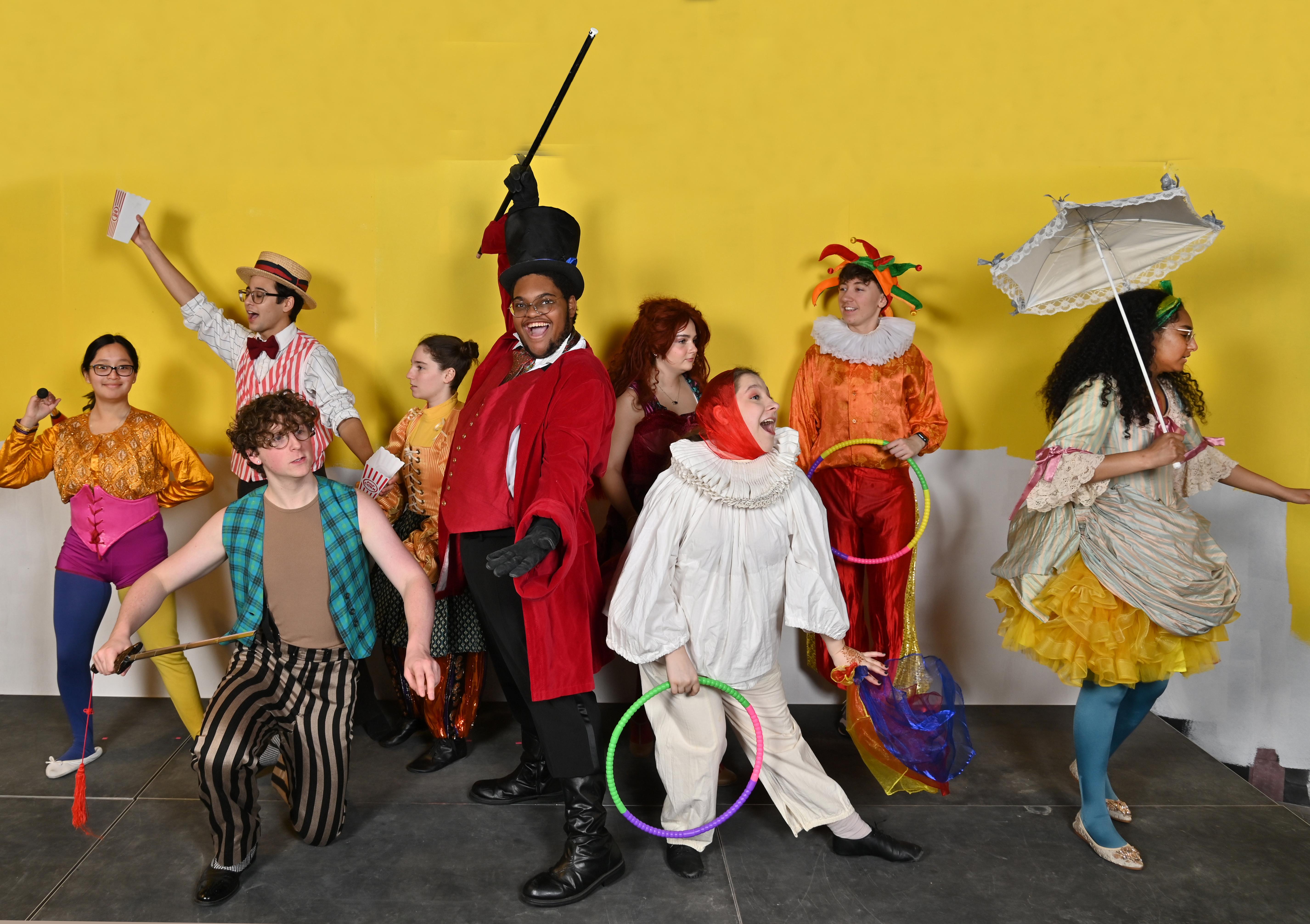 Performers in circus attire pose in a production image for Tuck Everlasting