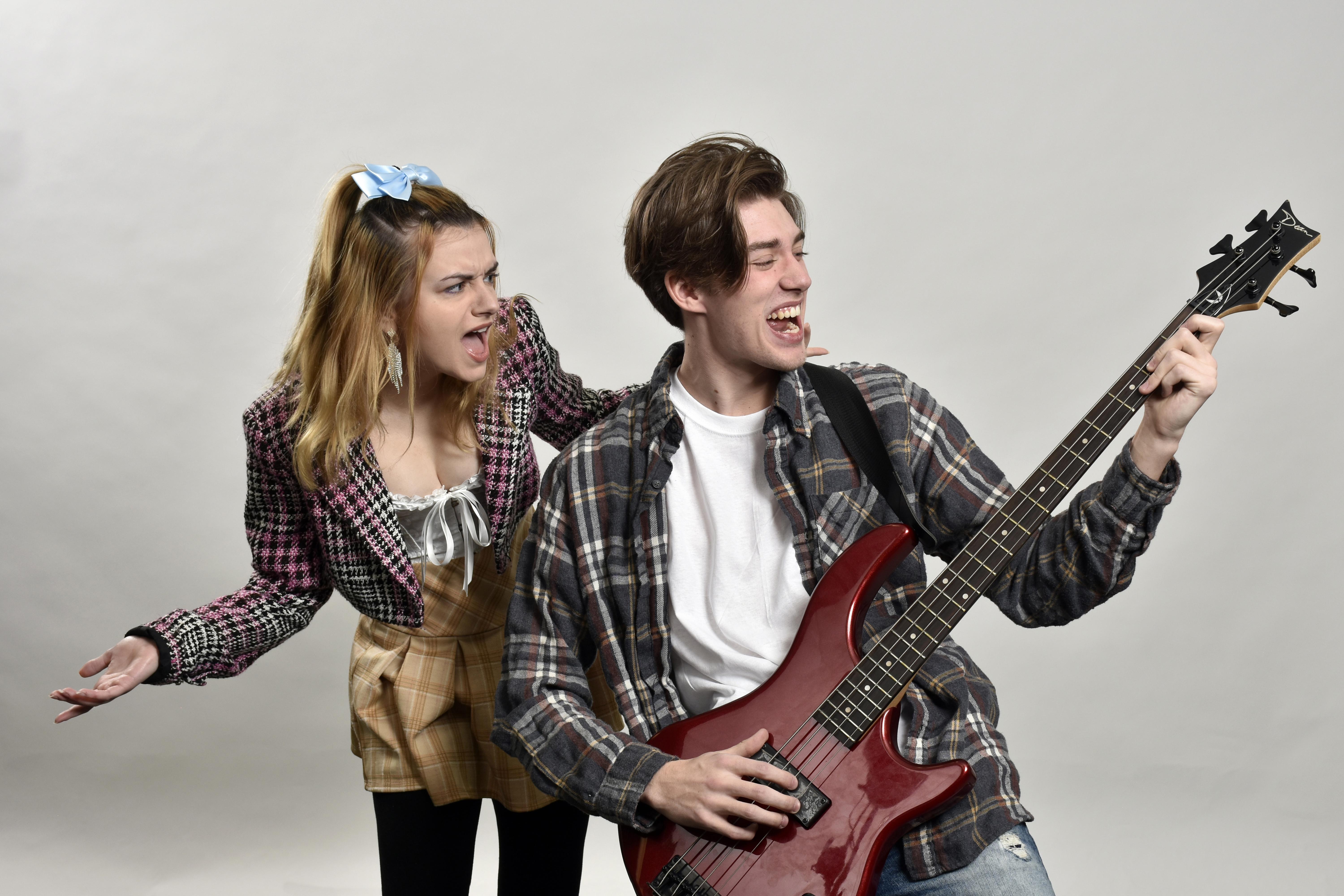 Rachel Leotta, at left, and Brock Whaley, at right playing a bass, are among the ensemble cast of The Wedding Singer