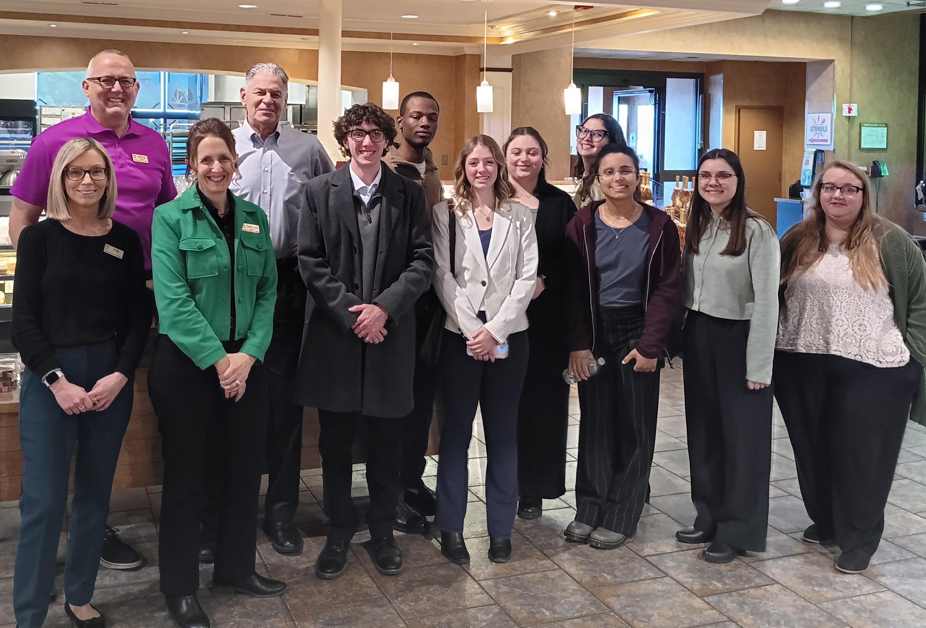 Kevin Stickles, senior vice president human resources at Wegmans Food Markets and a 1990 SUNY Oswego graduate, guided SUNY Oswego Society for Human Resource Management members on a recent tour