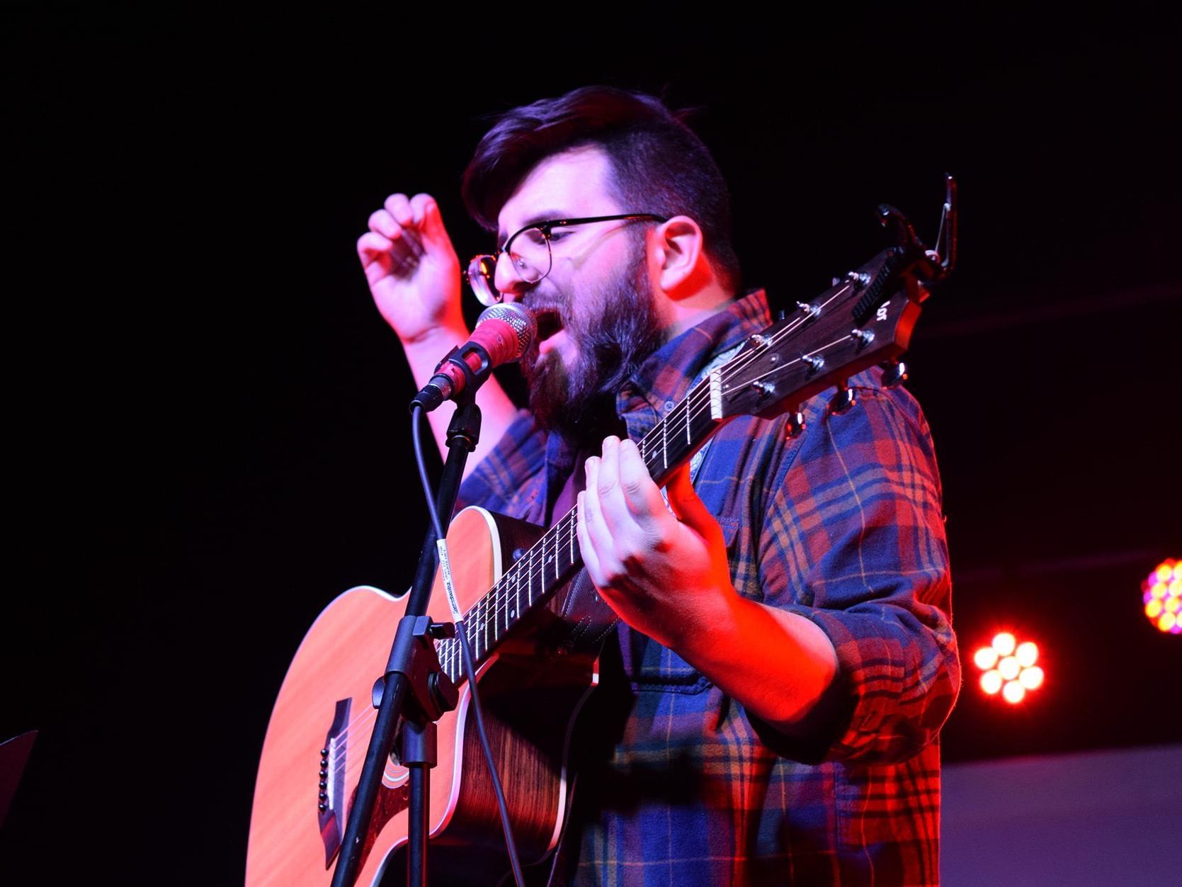 Zach Robinson plays the guitar and sings