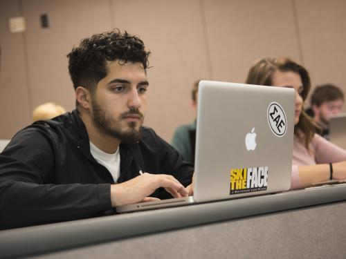 Student taking notes in class